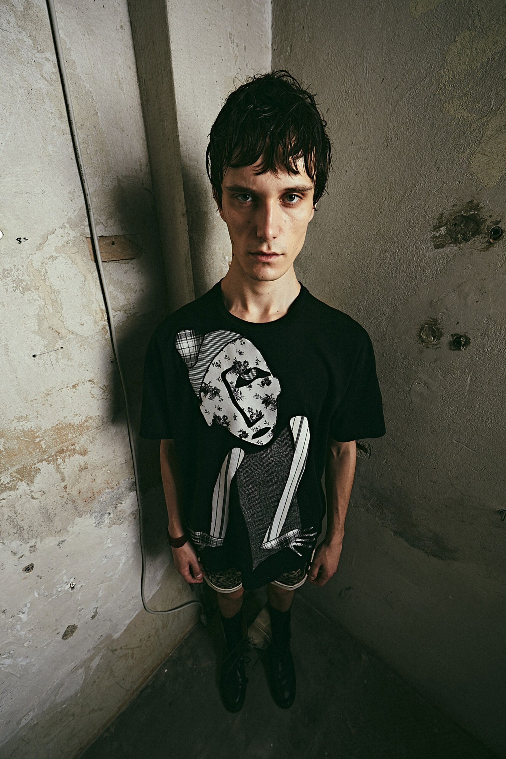 black printed t-shirt and checkered shorts