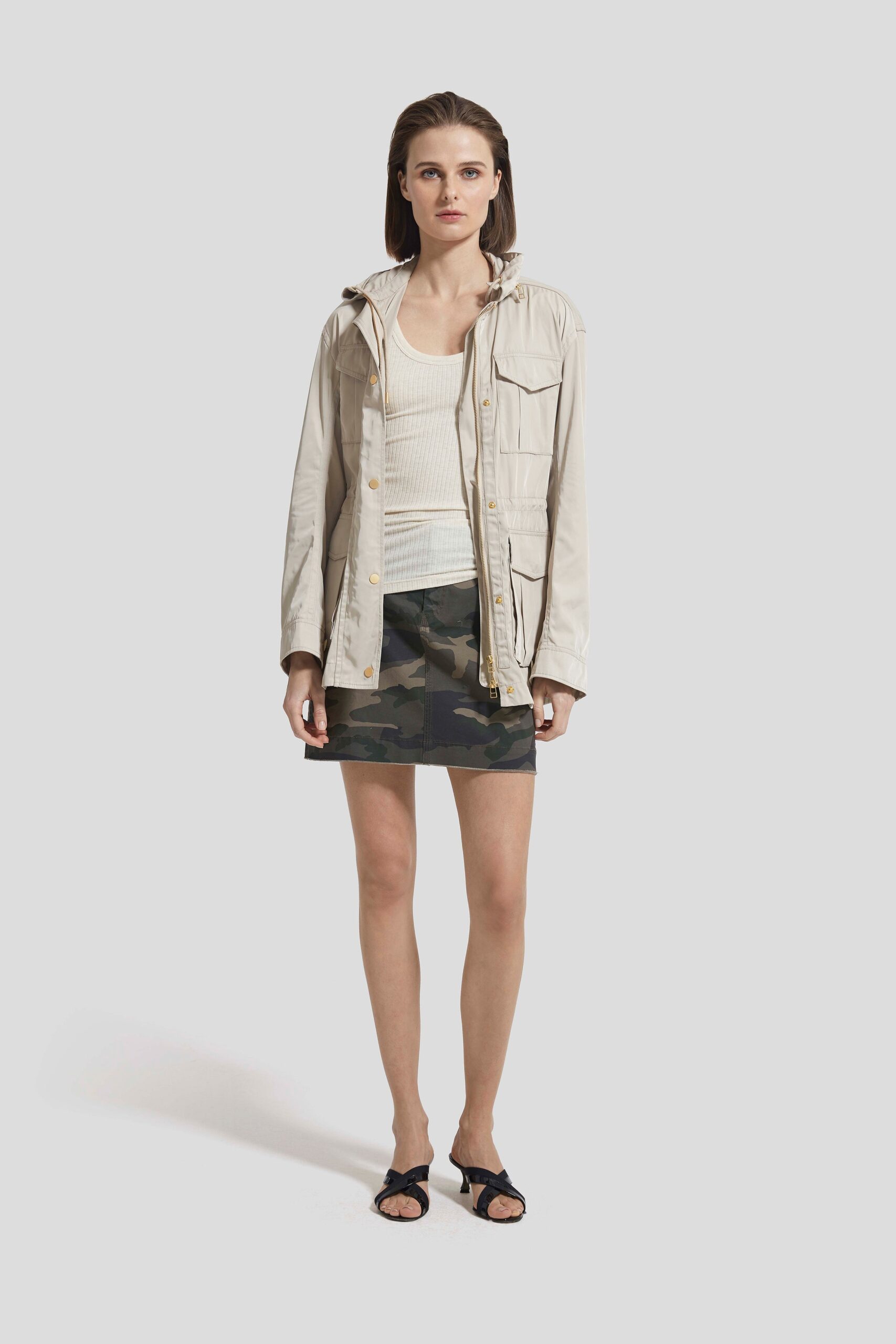 beige jacket white top camouflage skirt