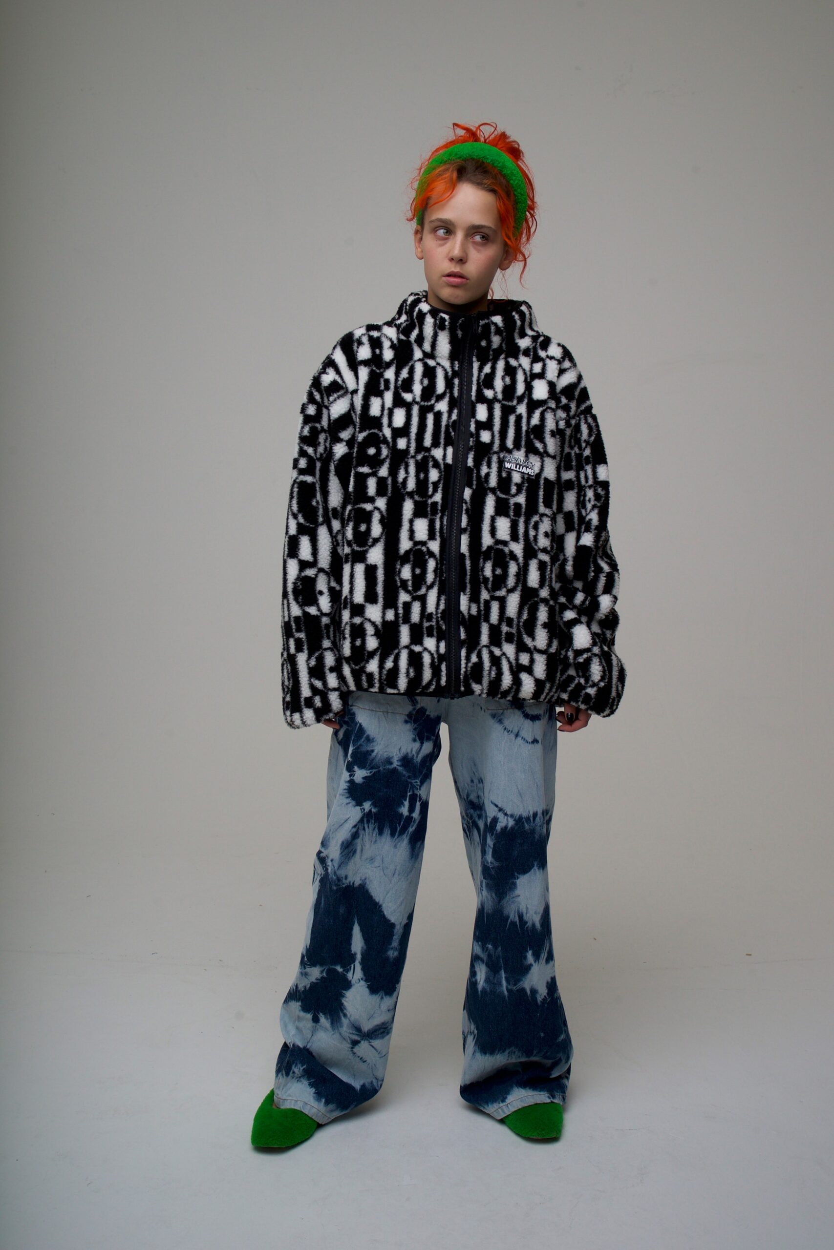 black and white faux-fur jacket with distressed denim pants