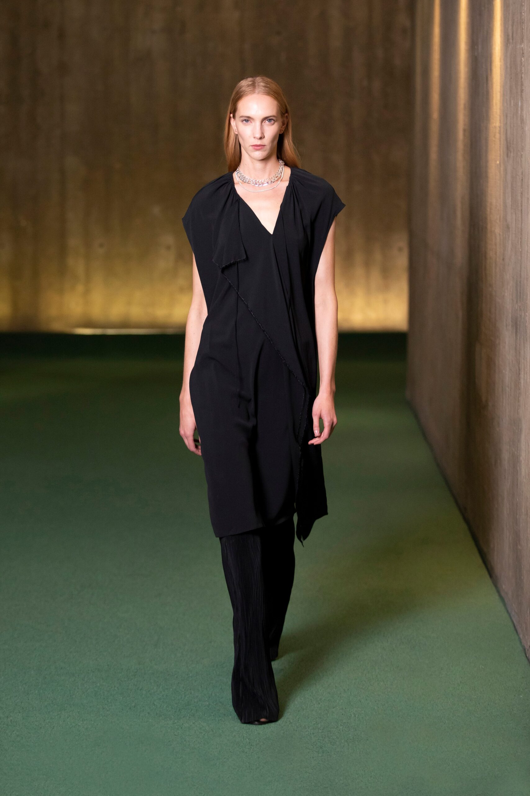 black silk draped midi dress and pleated pants