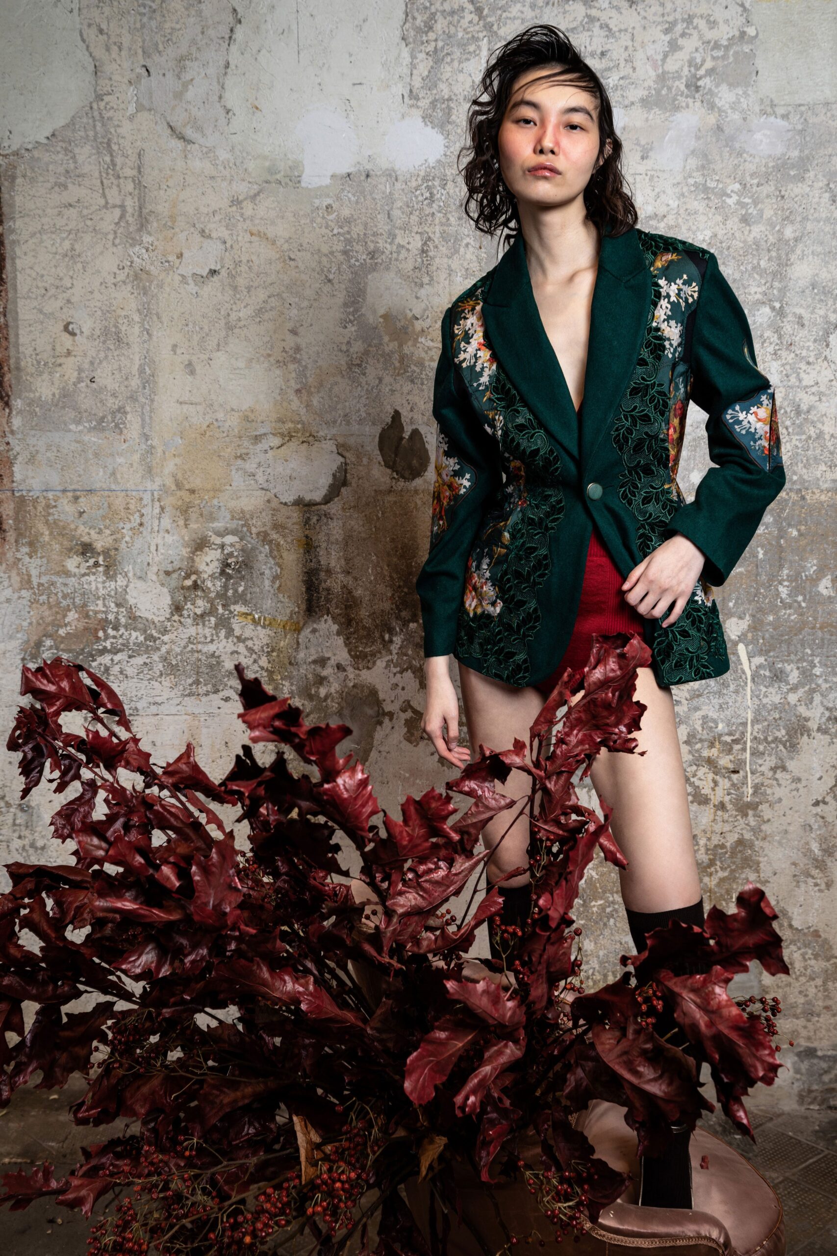 green embroidered blazer with red shorts