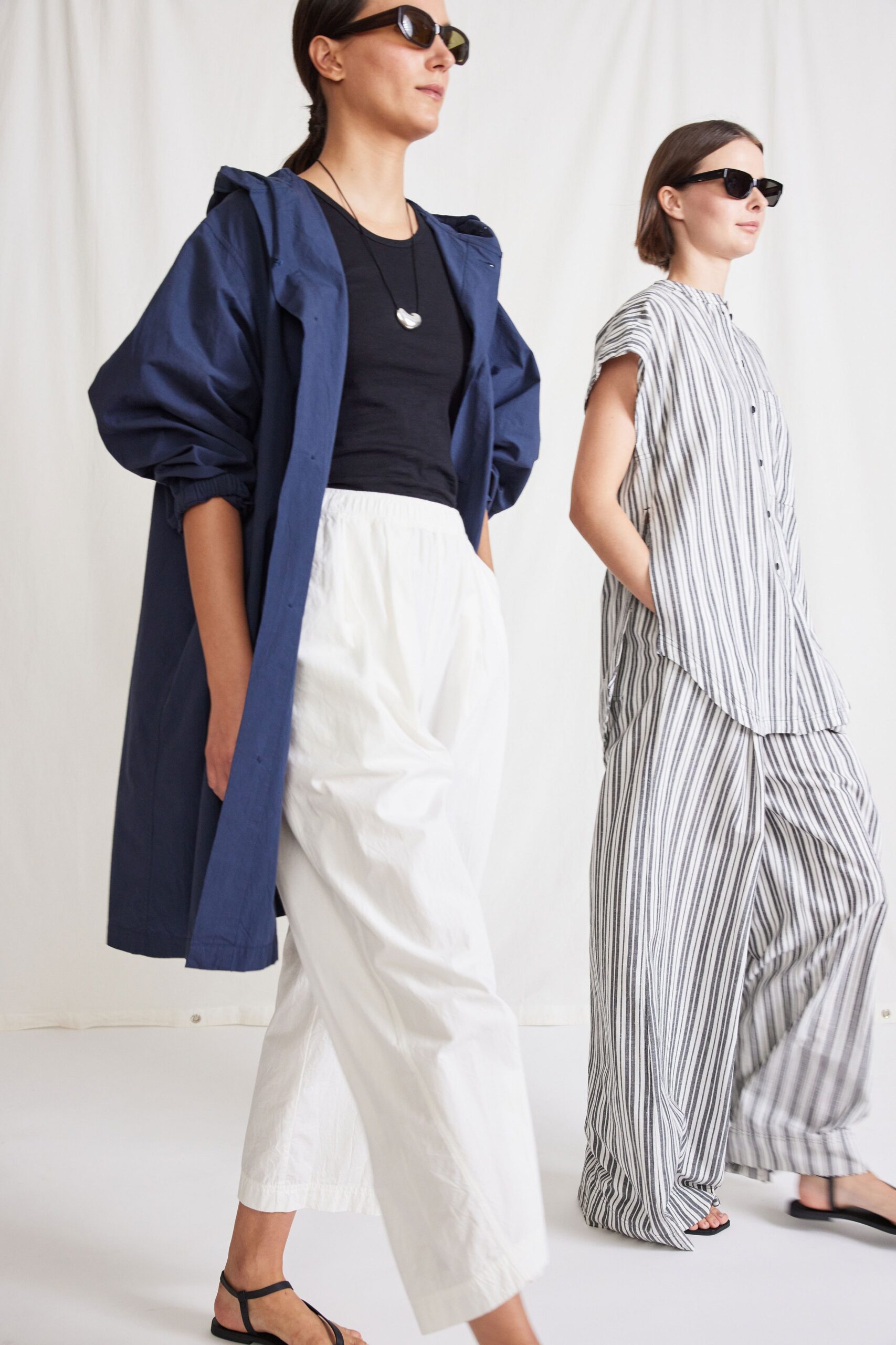 blue coat black top white pants