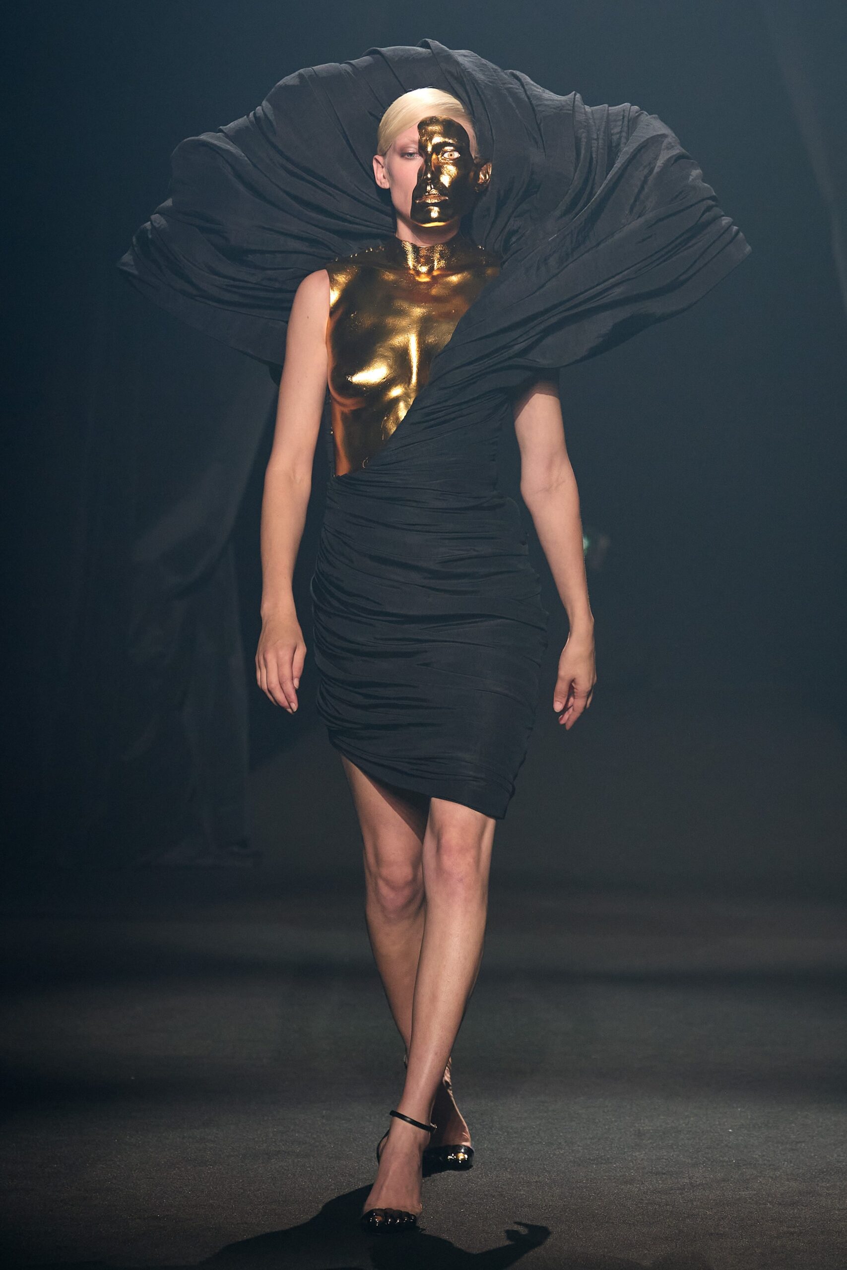black fitted mini dress with gold accent