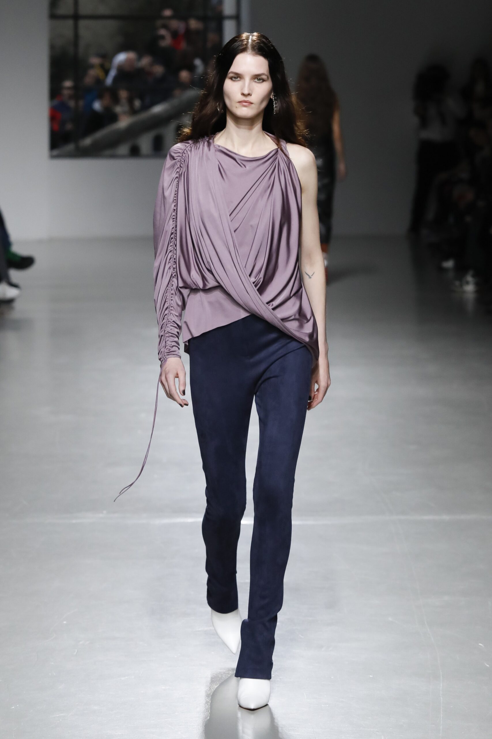 purple draped top with blue pants