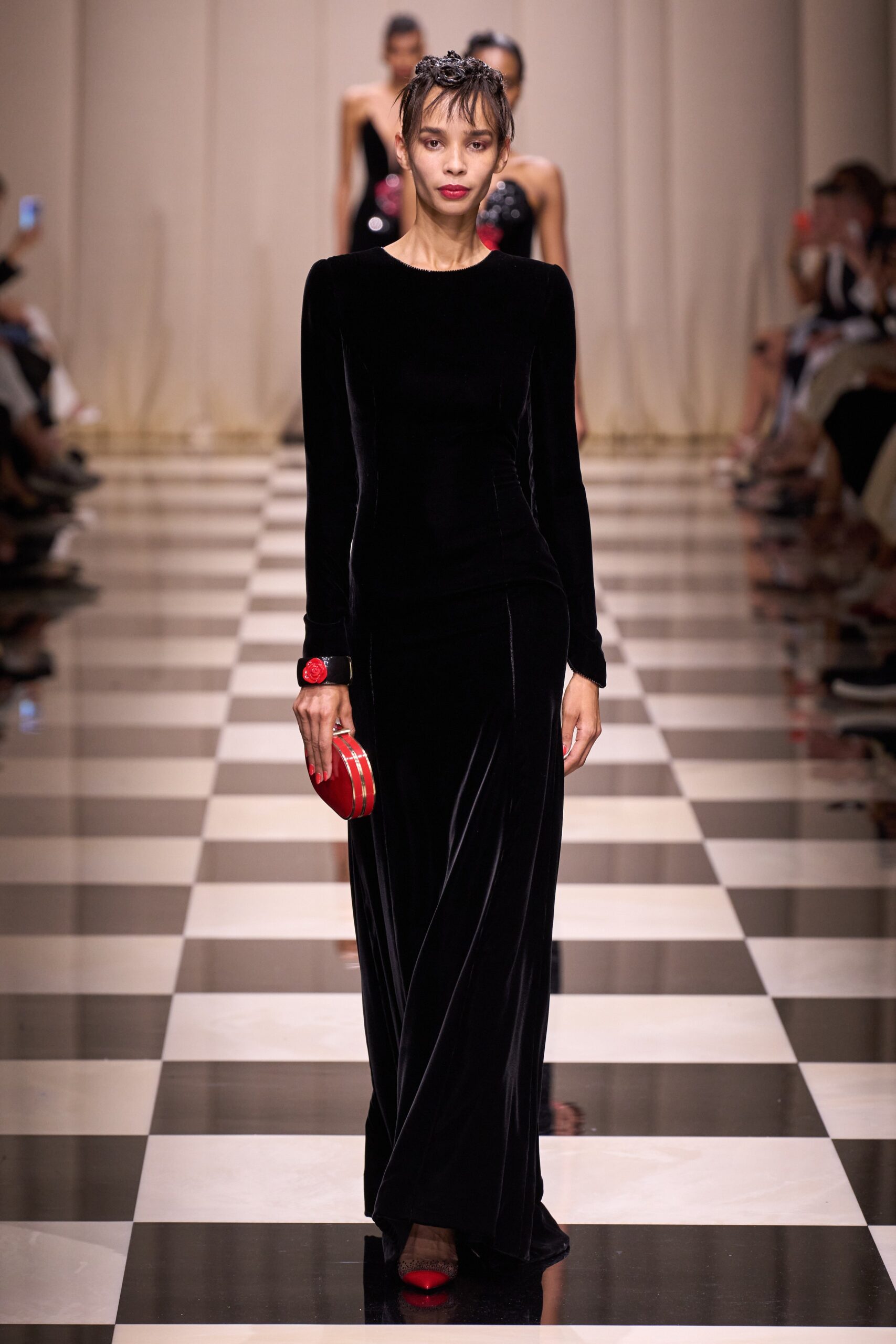 black velvet fitted gown with red clutch