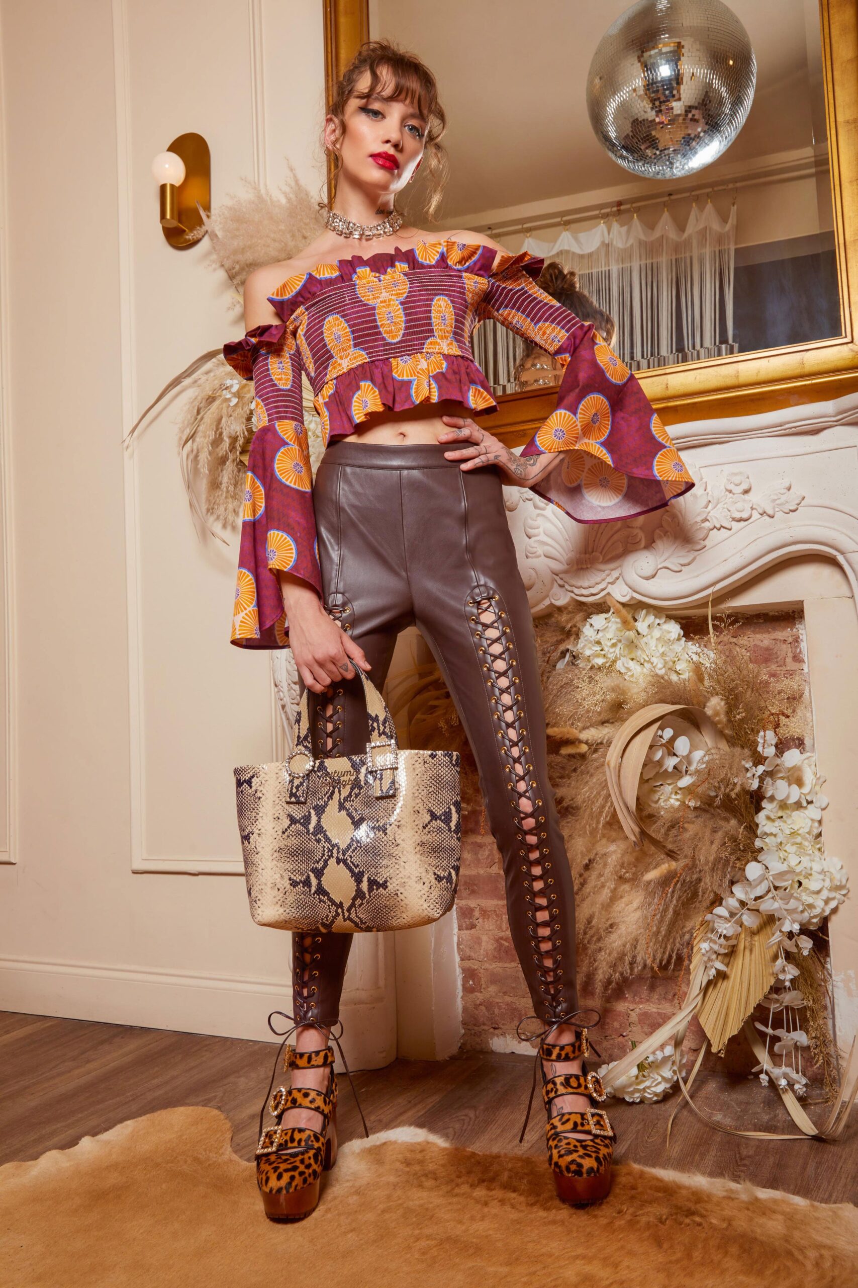 purple off-shoulder top with brown leather pants