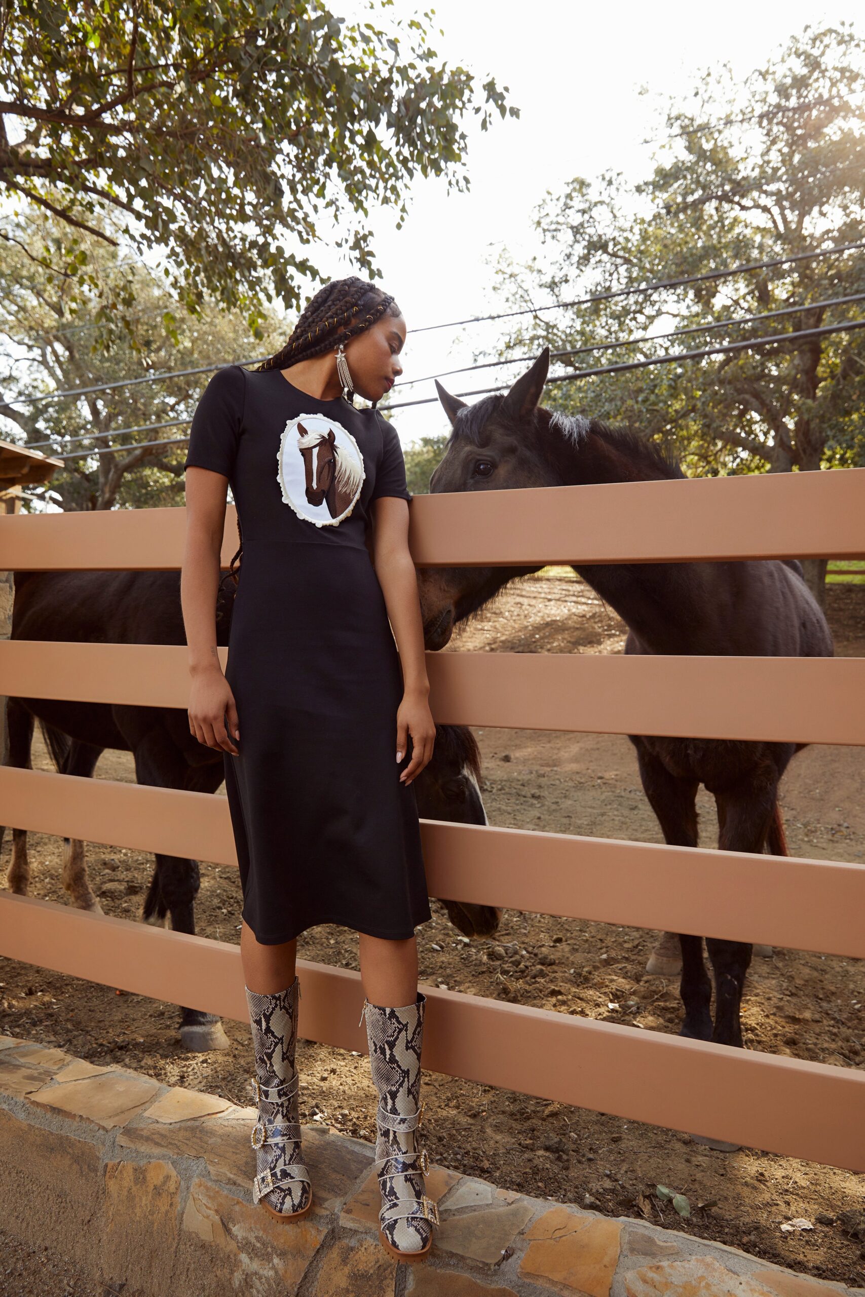 black fitted midi dress with animal-print boots