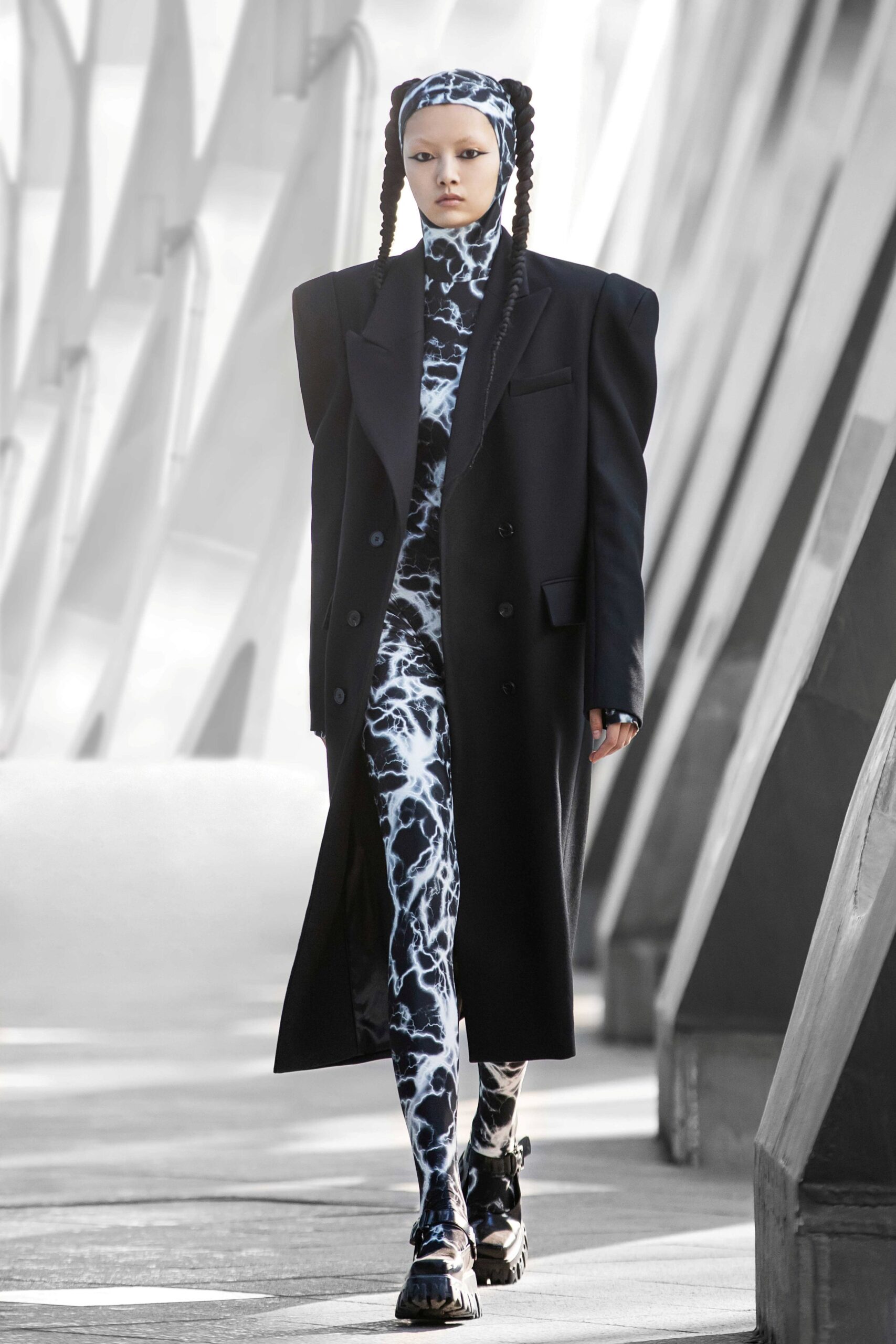 oversized black coat and fitted catsuit