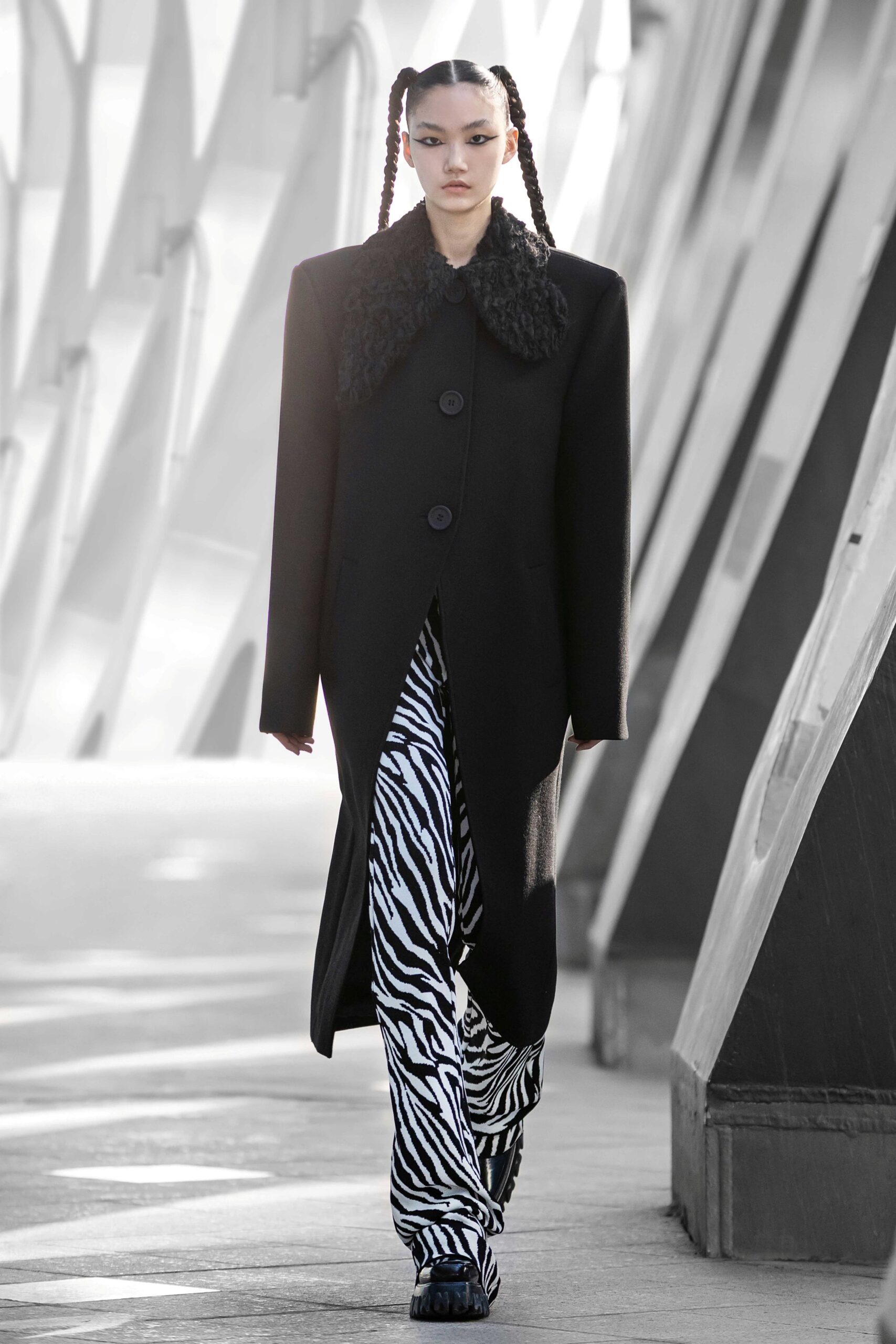 oversized black wool coat with animal-print pants