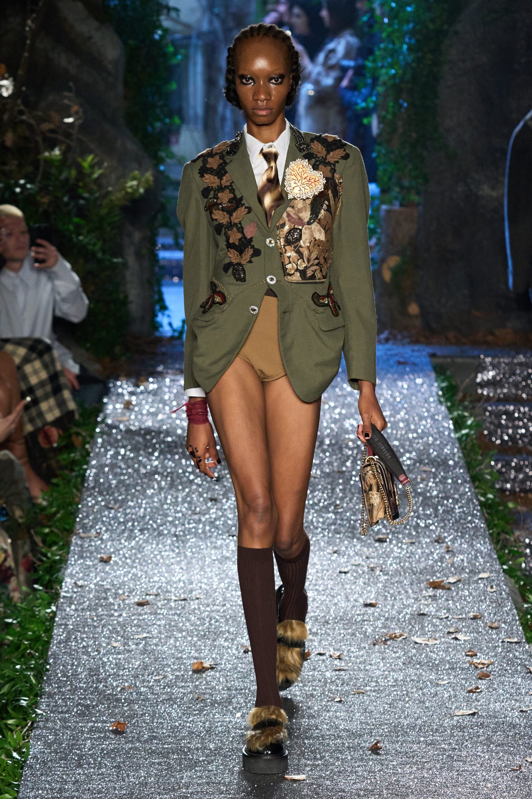 green tailored blazer with beige shorts