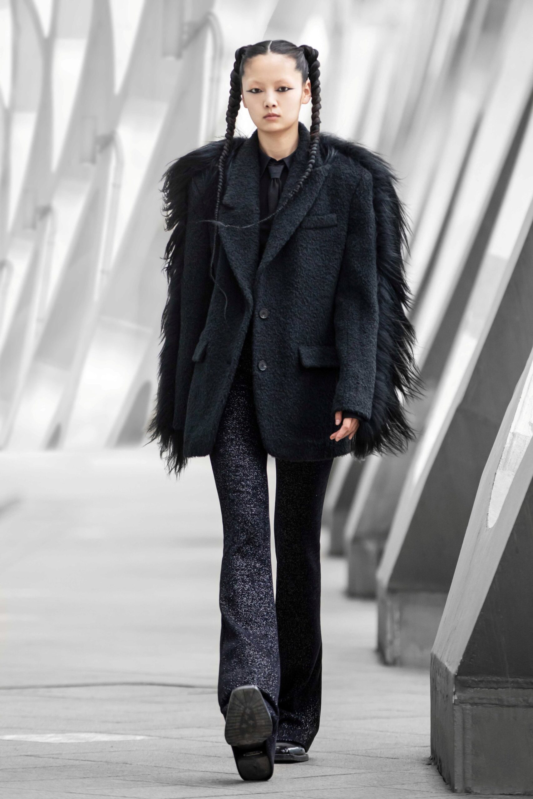 black oversized fur coat and flared pants