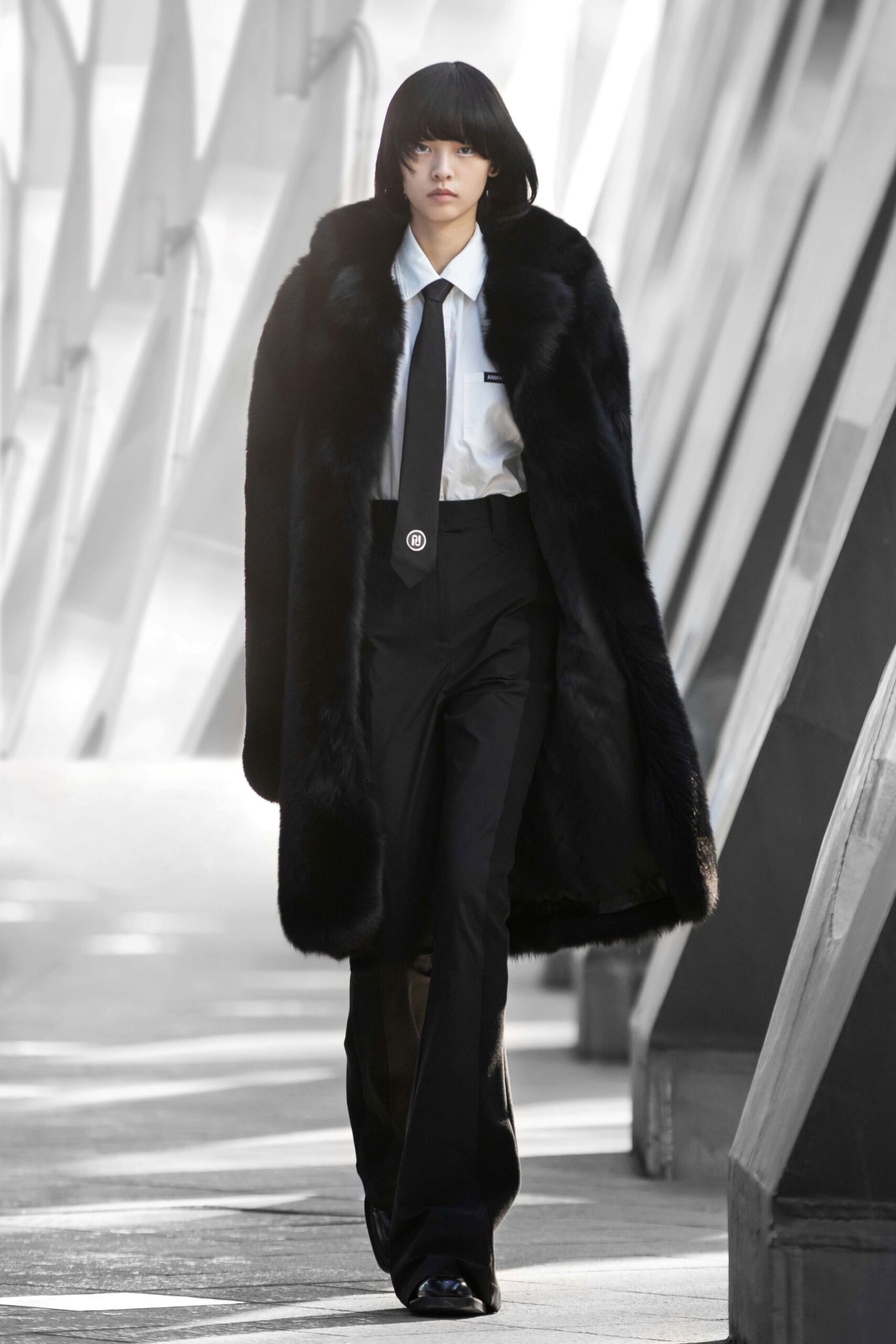 black faux-fur coat with tailored pants