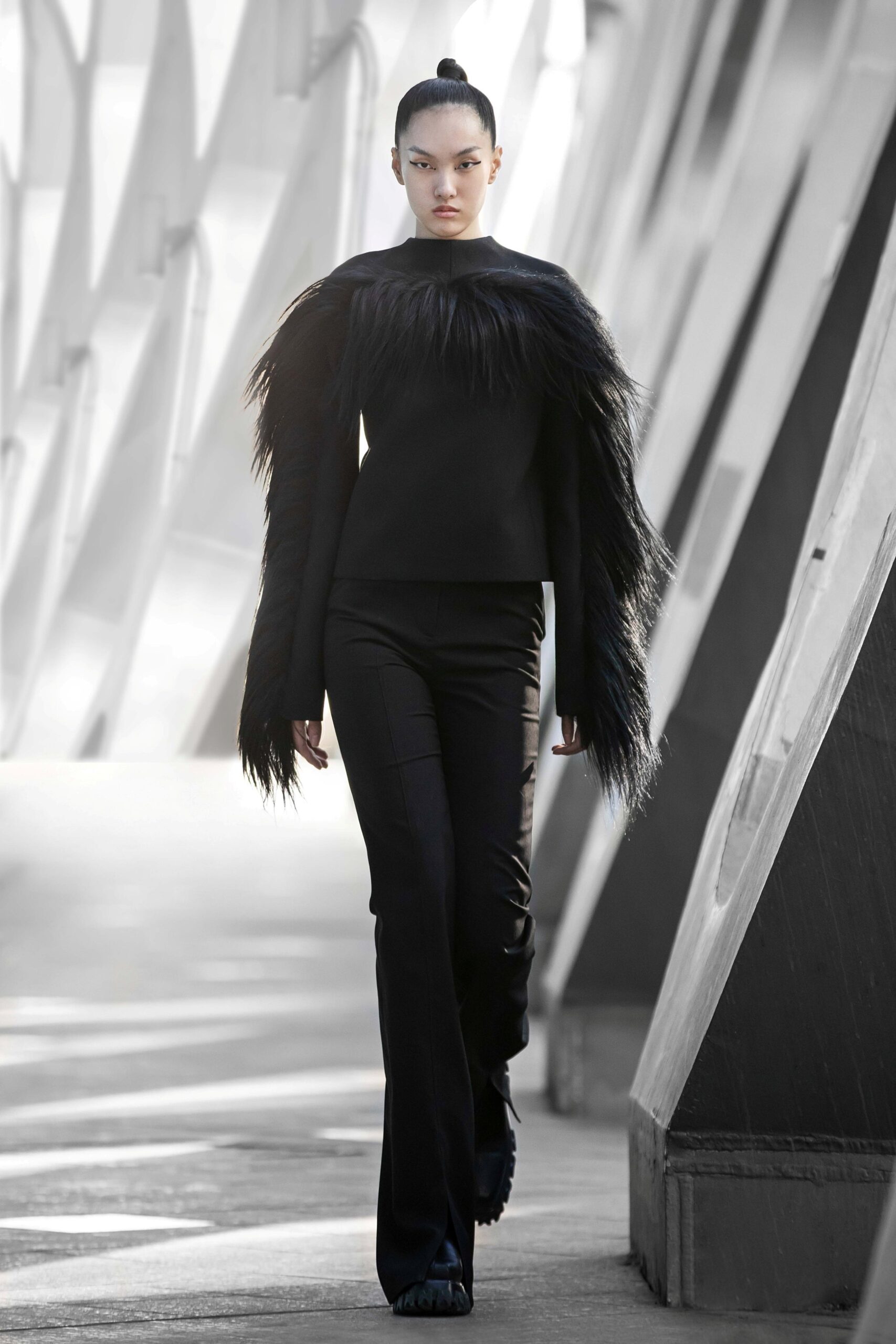 black fitted faux-fur top with tailored pants