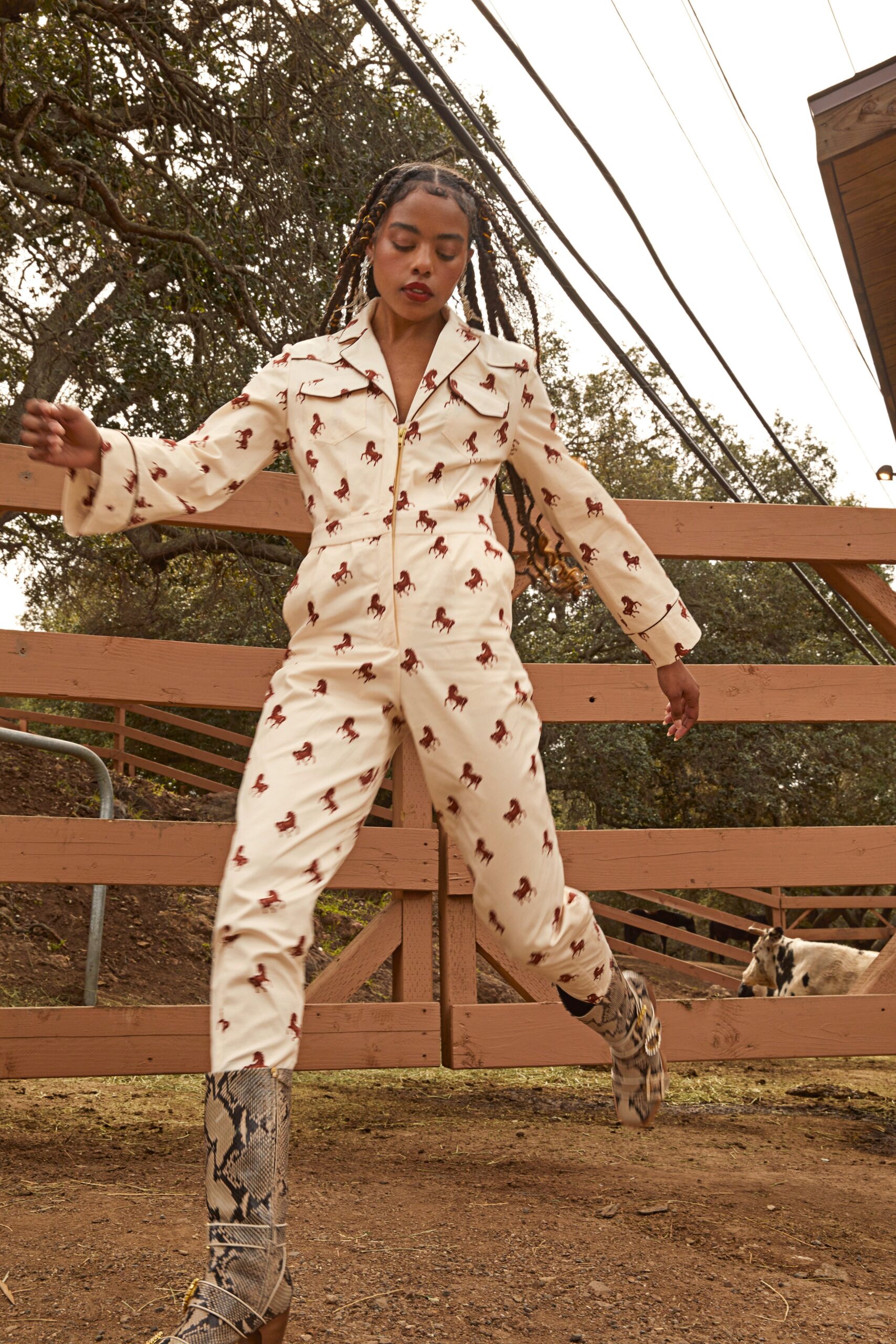 white printed jumpsuit with gray boots