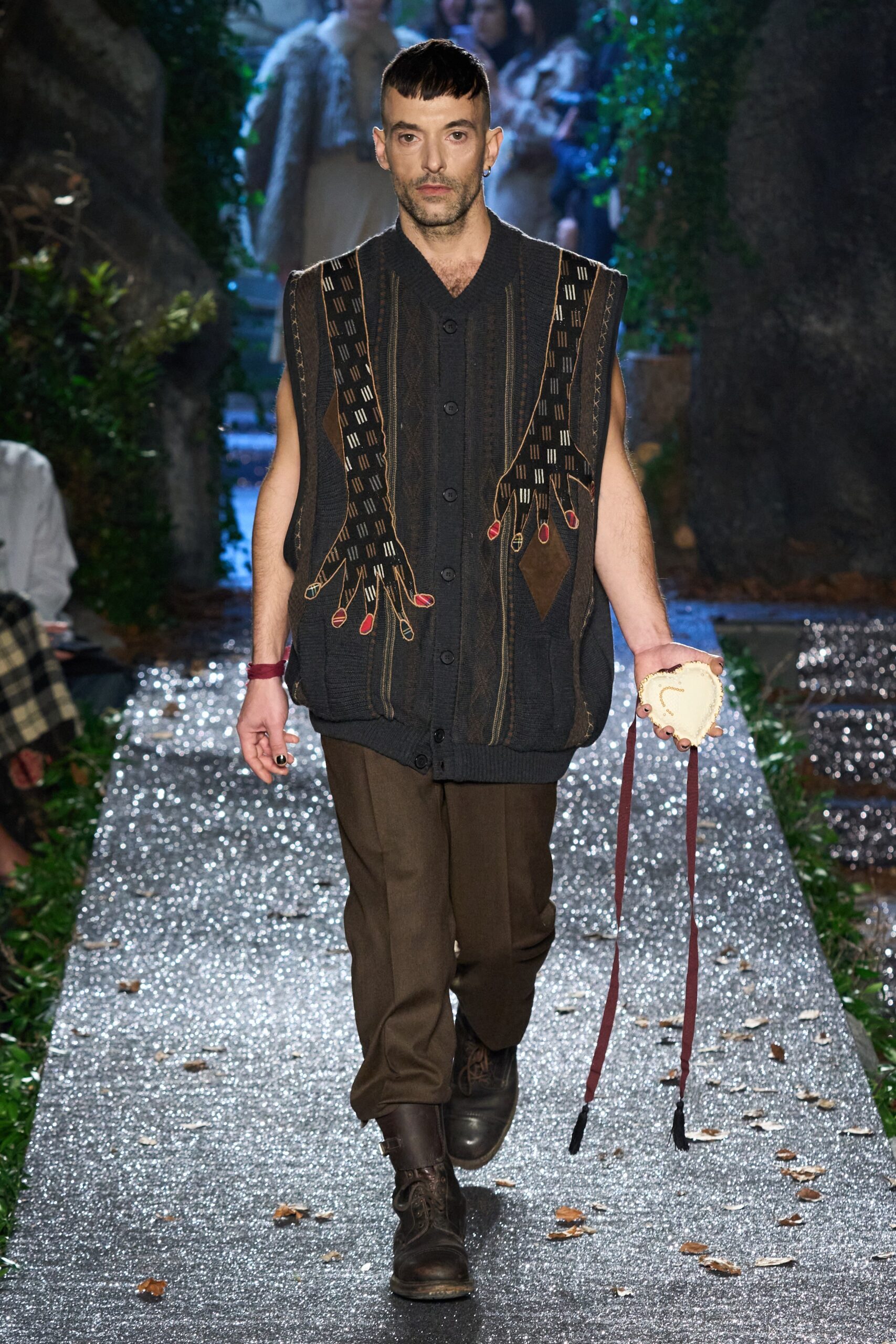 black embroidered vest with brown pants