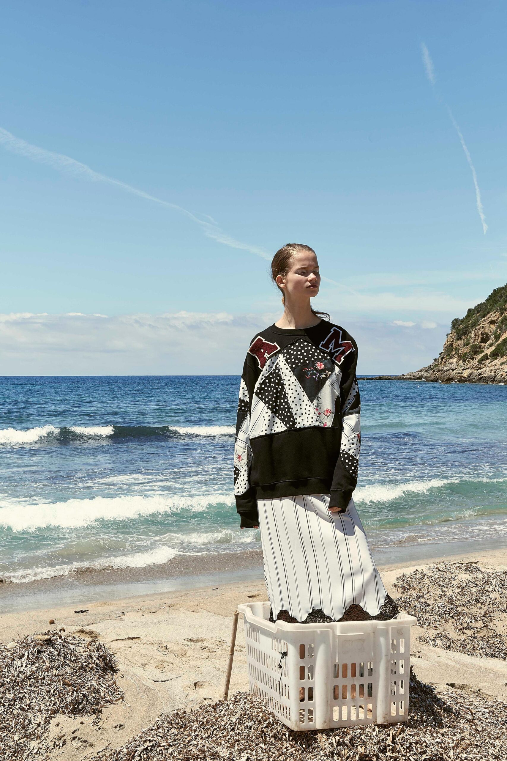 relaxed black sweater and pleated midi skirt