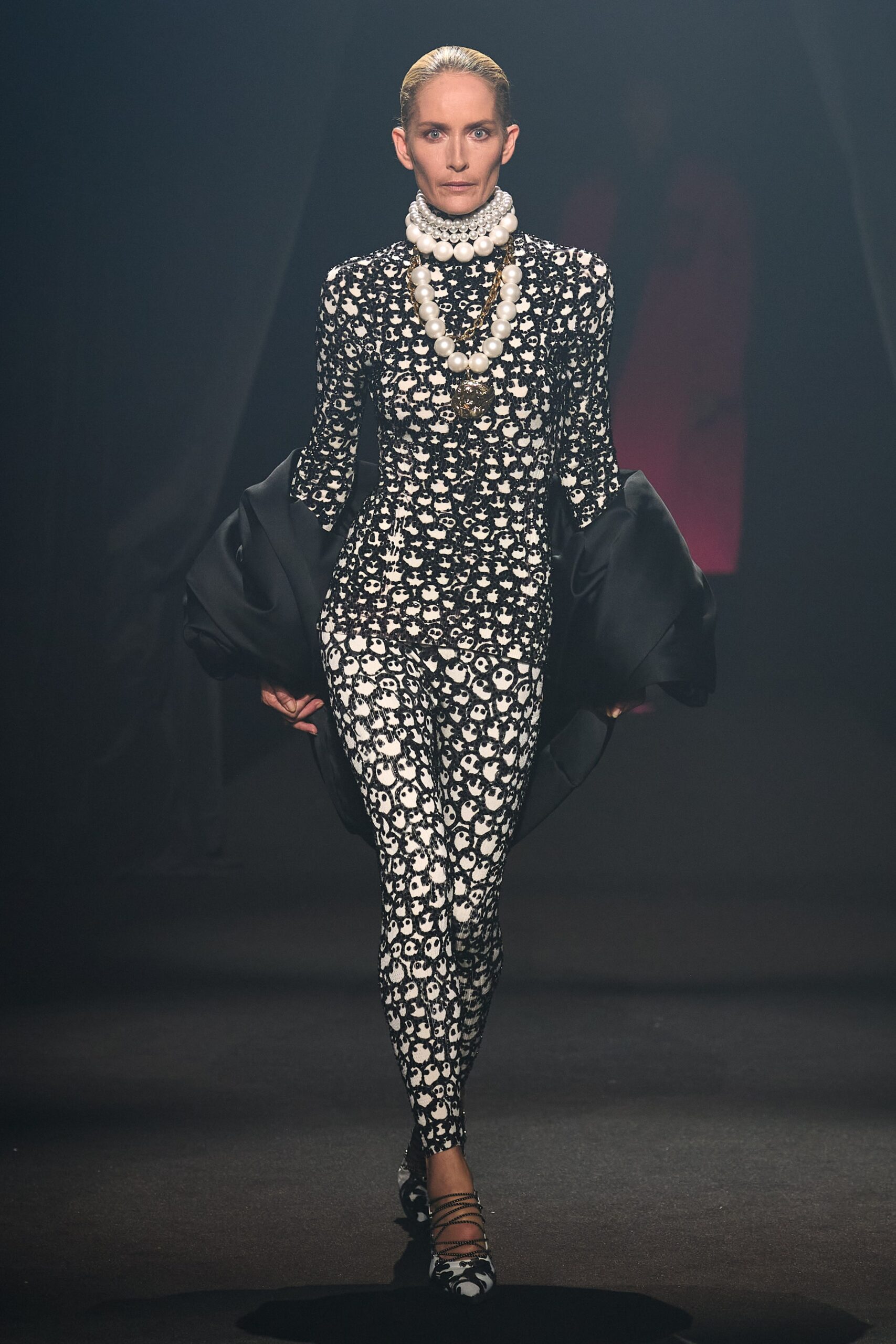 black and white printed catsuit with cape