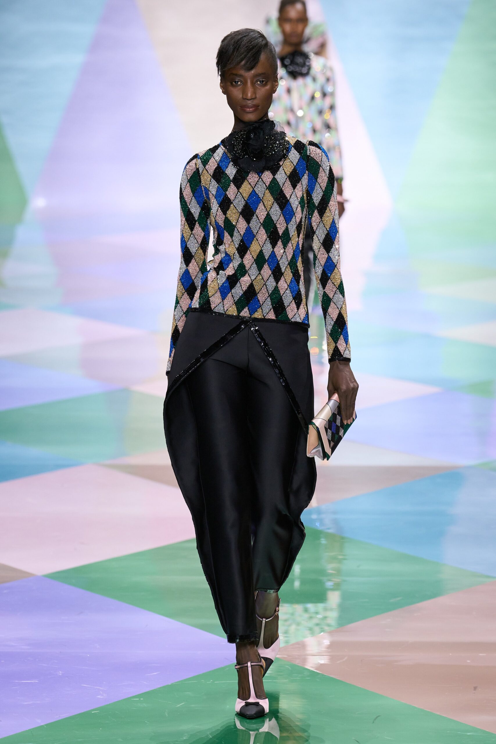 multi-colored fitted top with black pants