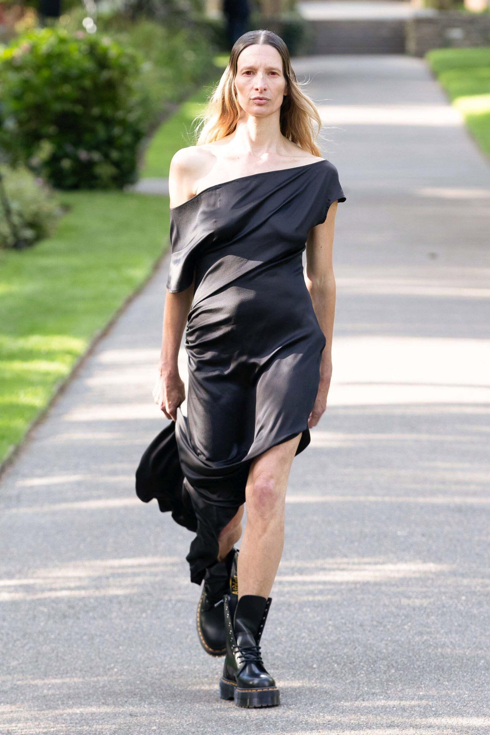 black off-shoulder draped dress with boots