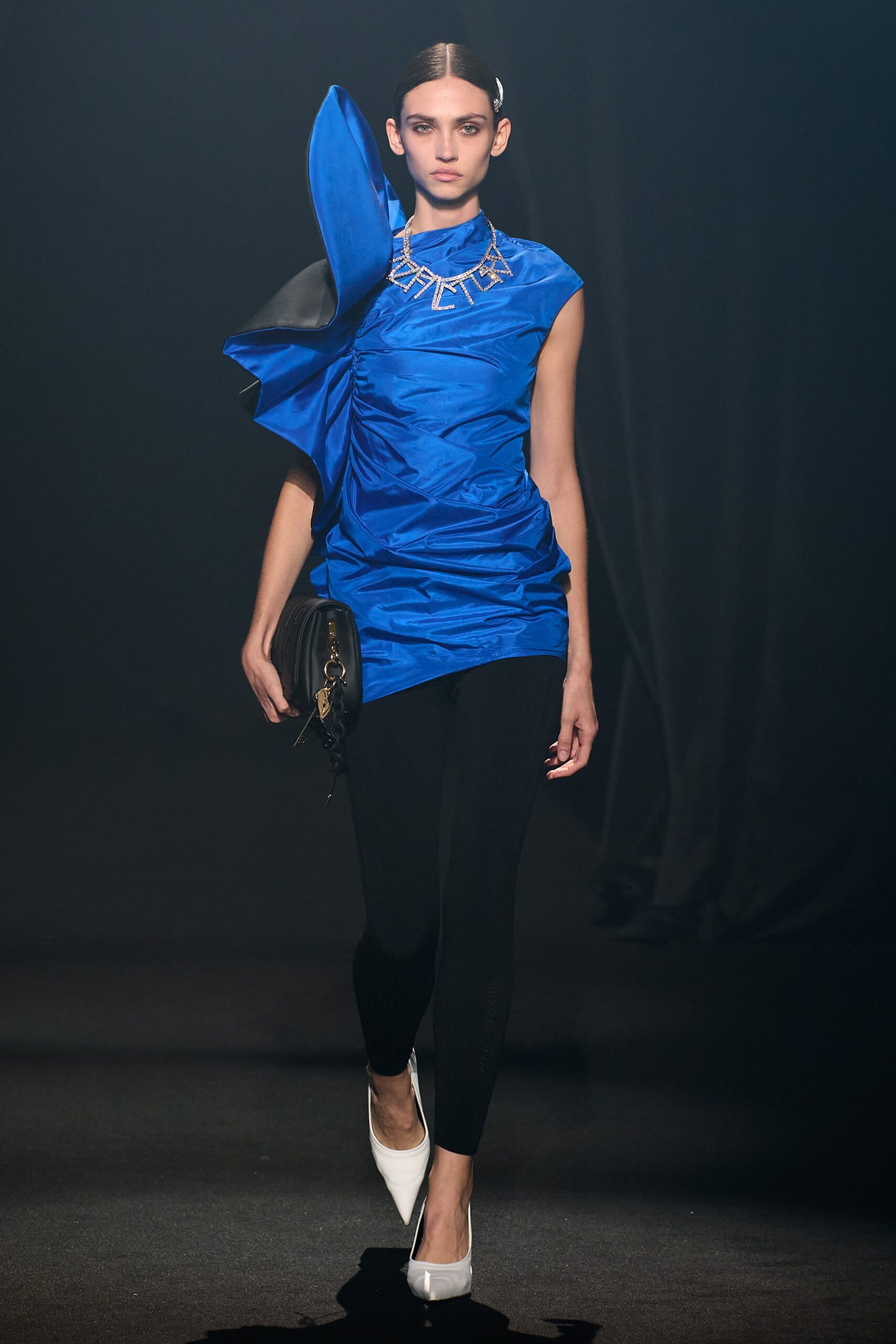 blue asymmetric silk top with black pants