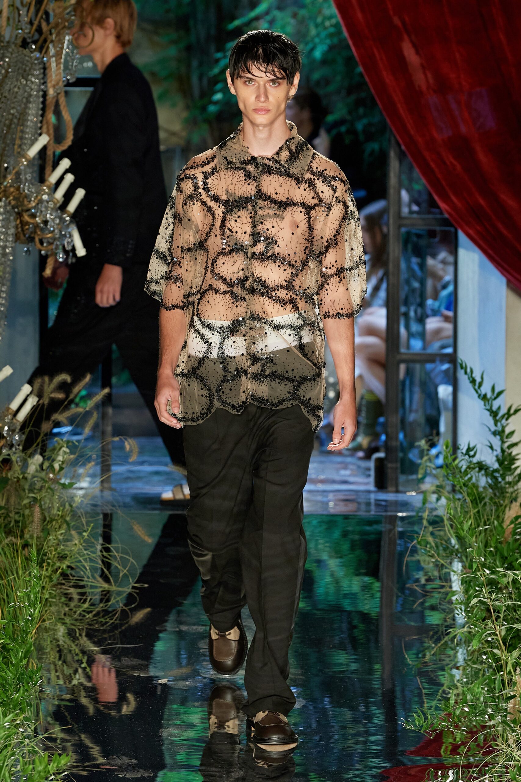 beige embroidered shirt and black pants