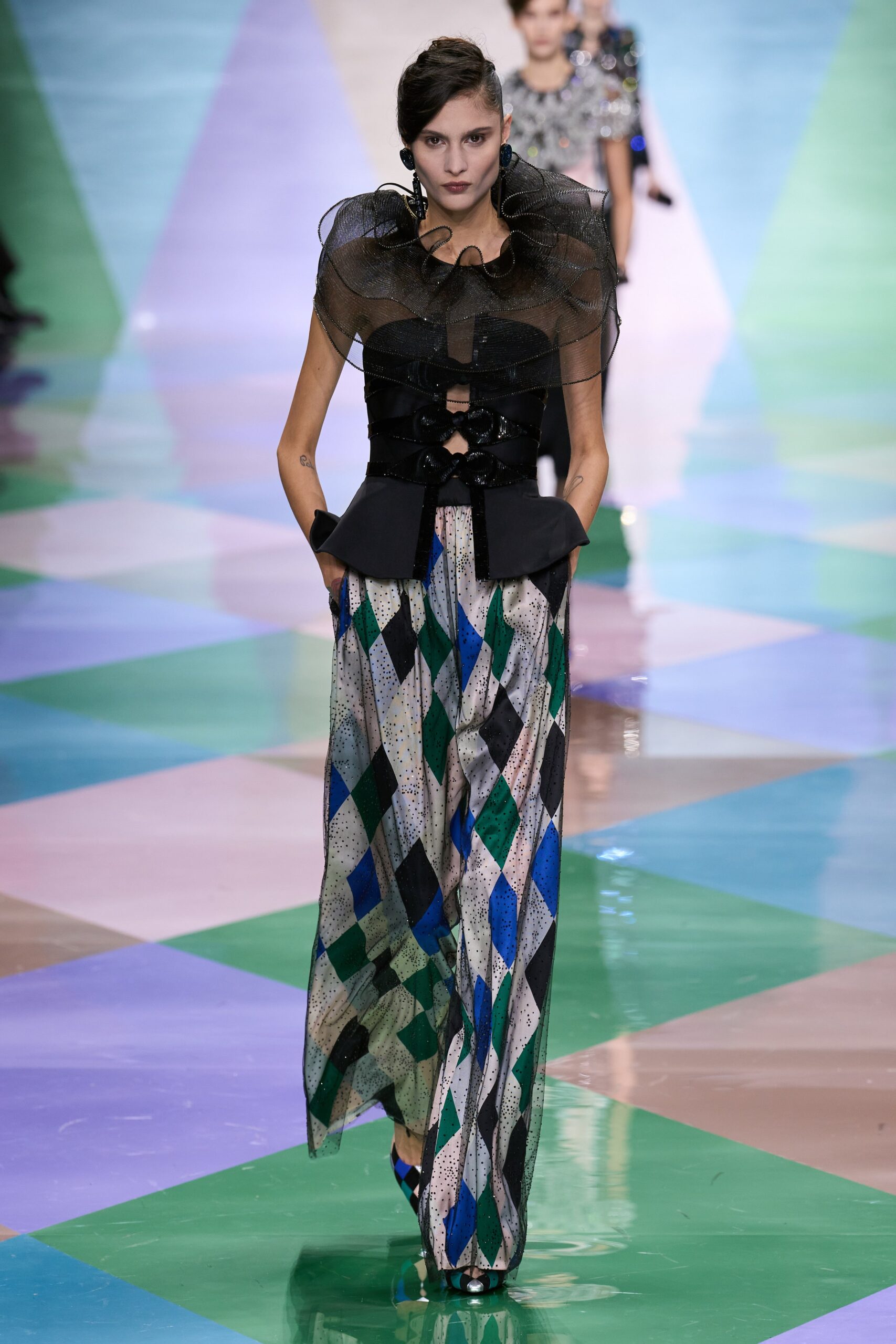 black ruffled top with multi pants