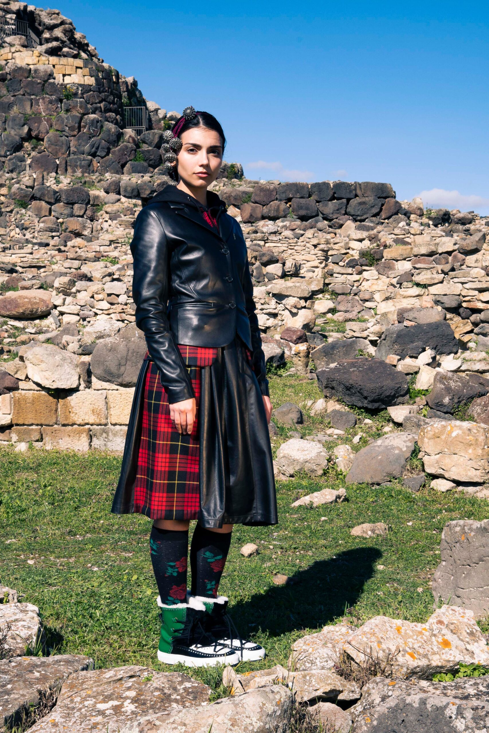 black leather jacket with pleated skirt