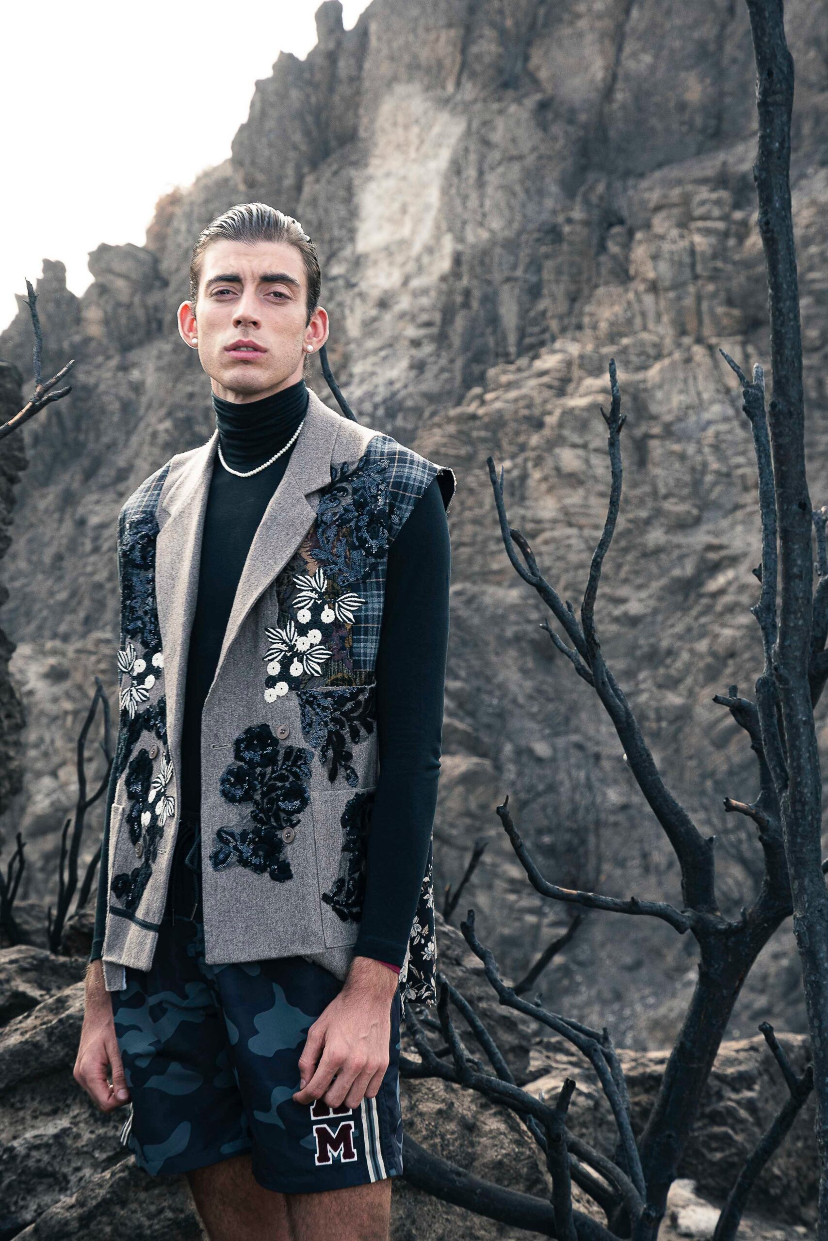 gray embroidered vest with black turtleneck