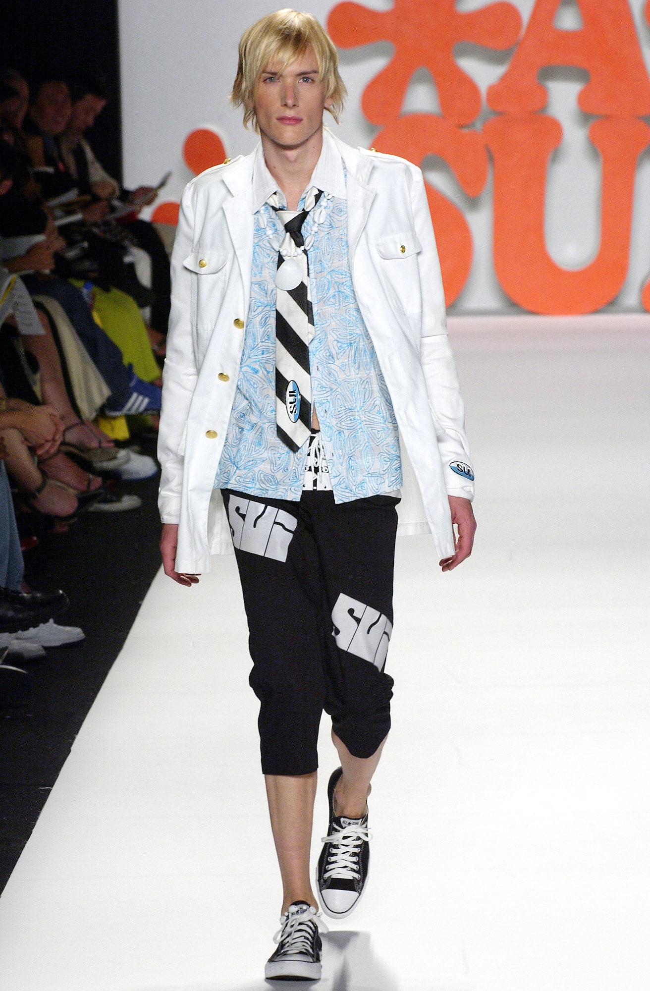 white jacket blue shirt black pants