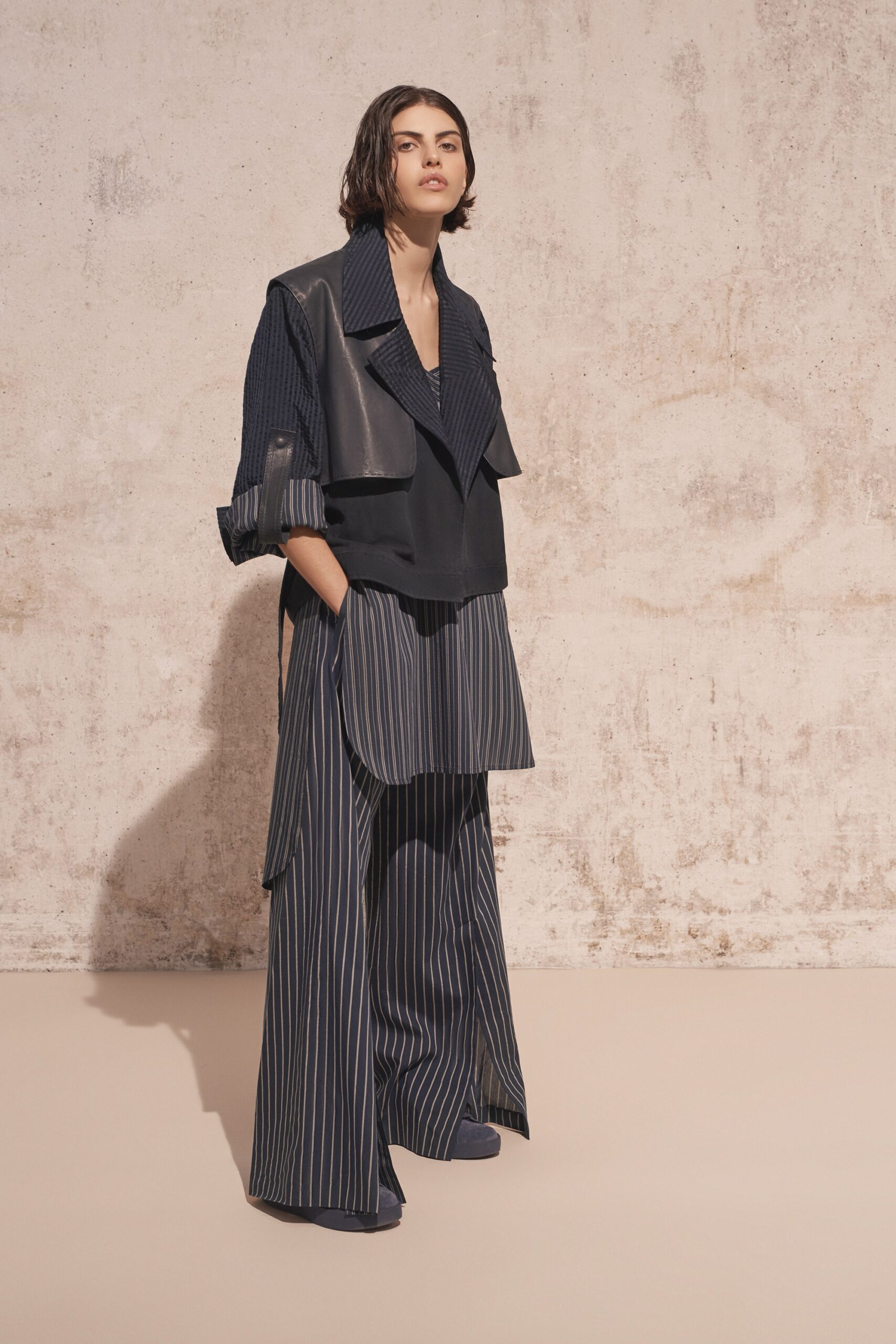 black leather relaxed jacket with blue striped pants