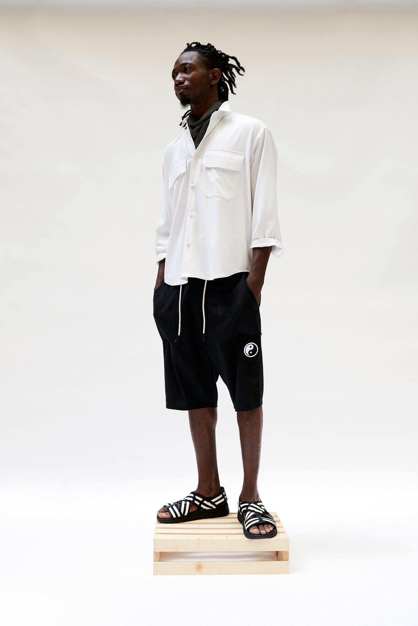 white relaxed shirt with black shorts
