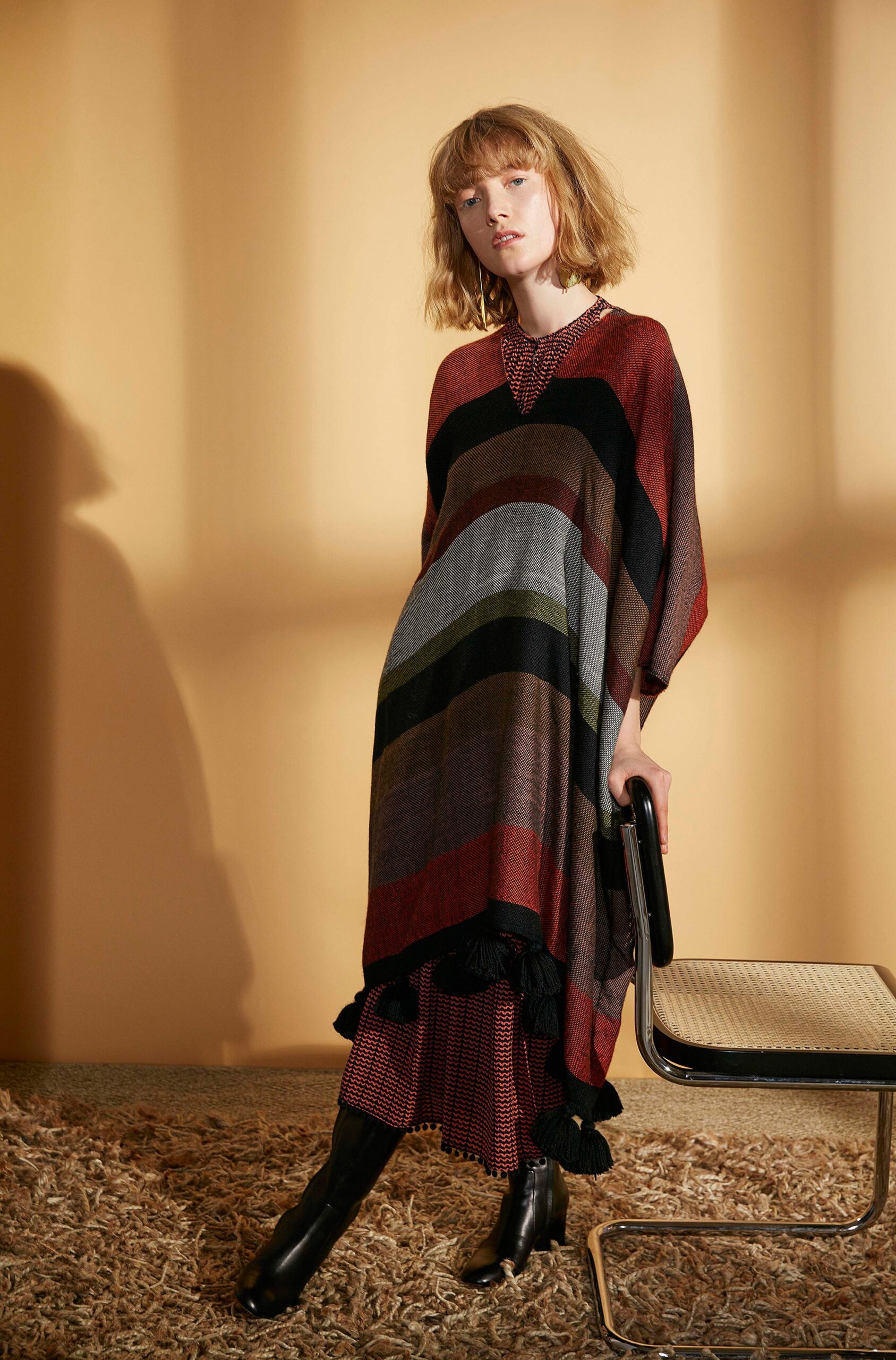 striped poncho layered over dress
