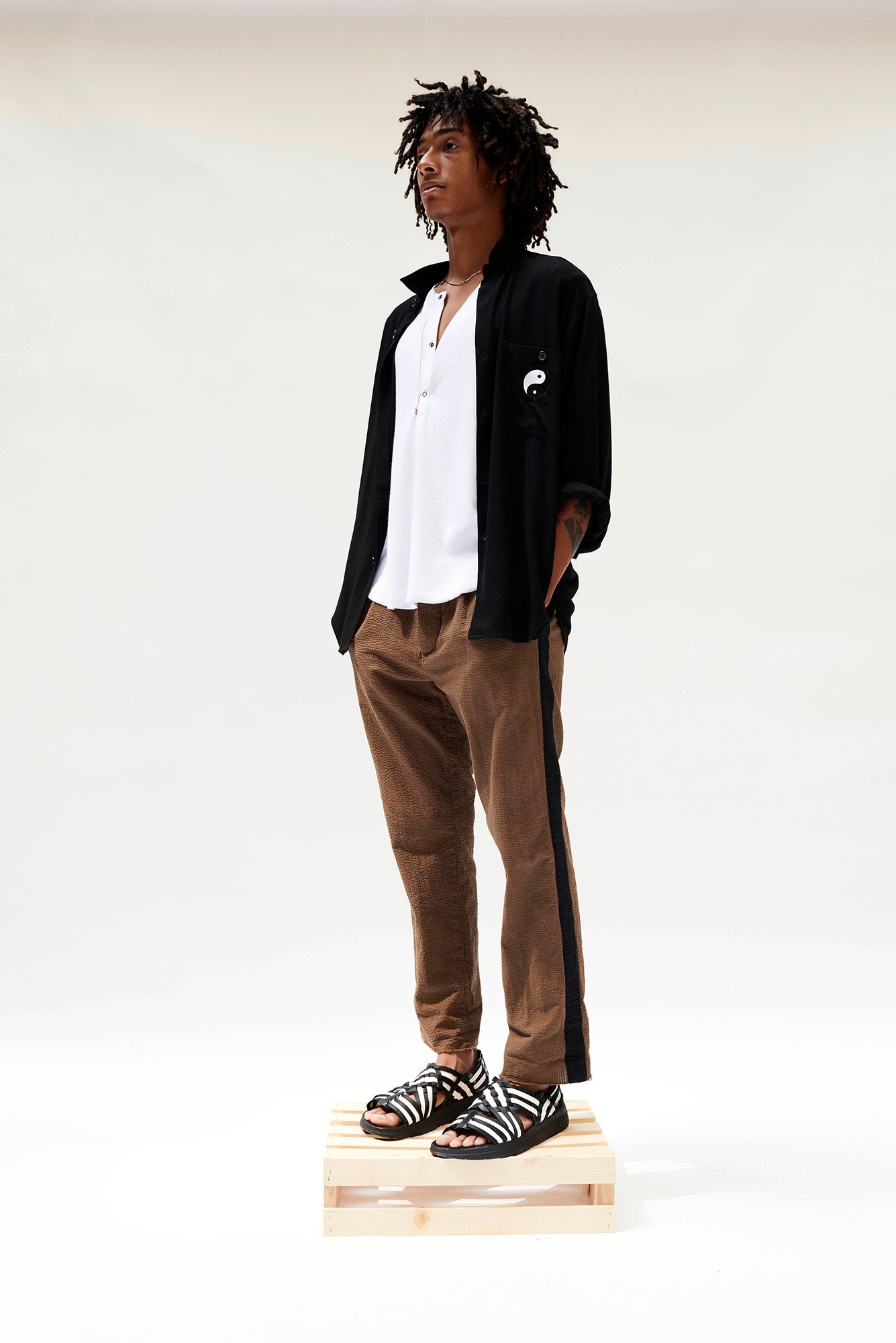 black shirt white top brown pants
