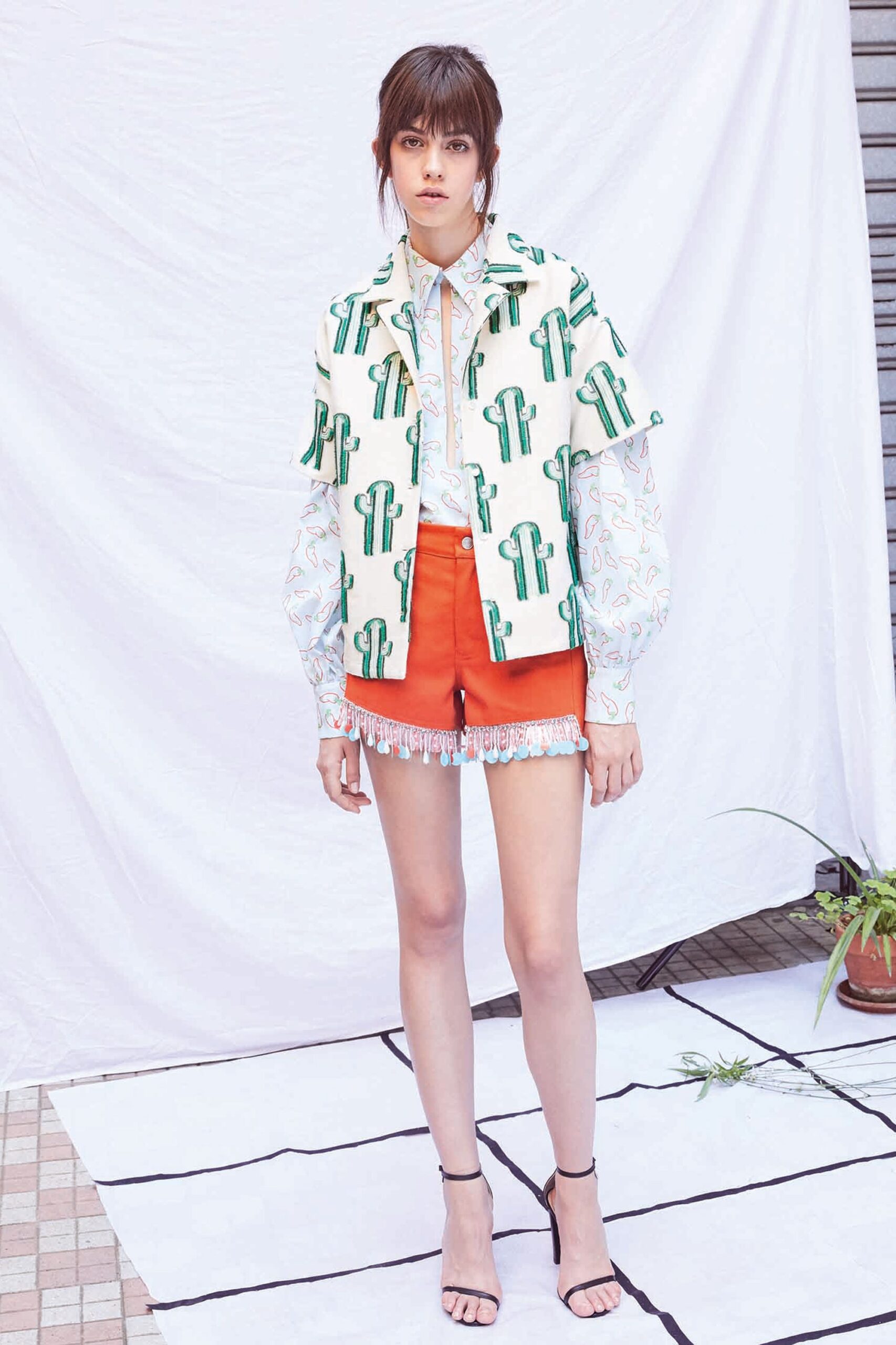 printed top and red shorts