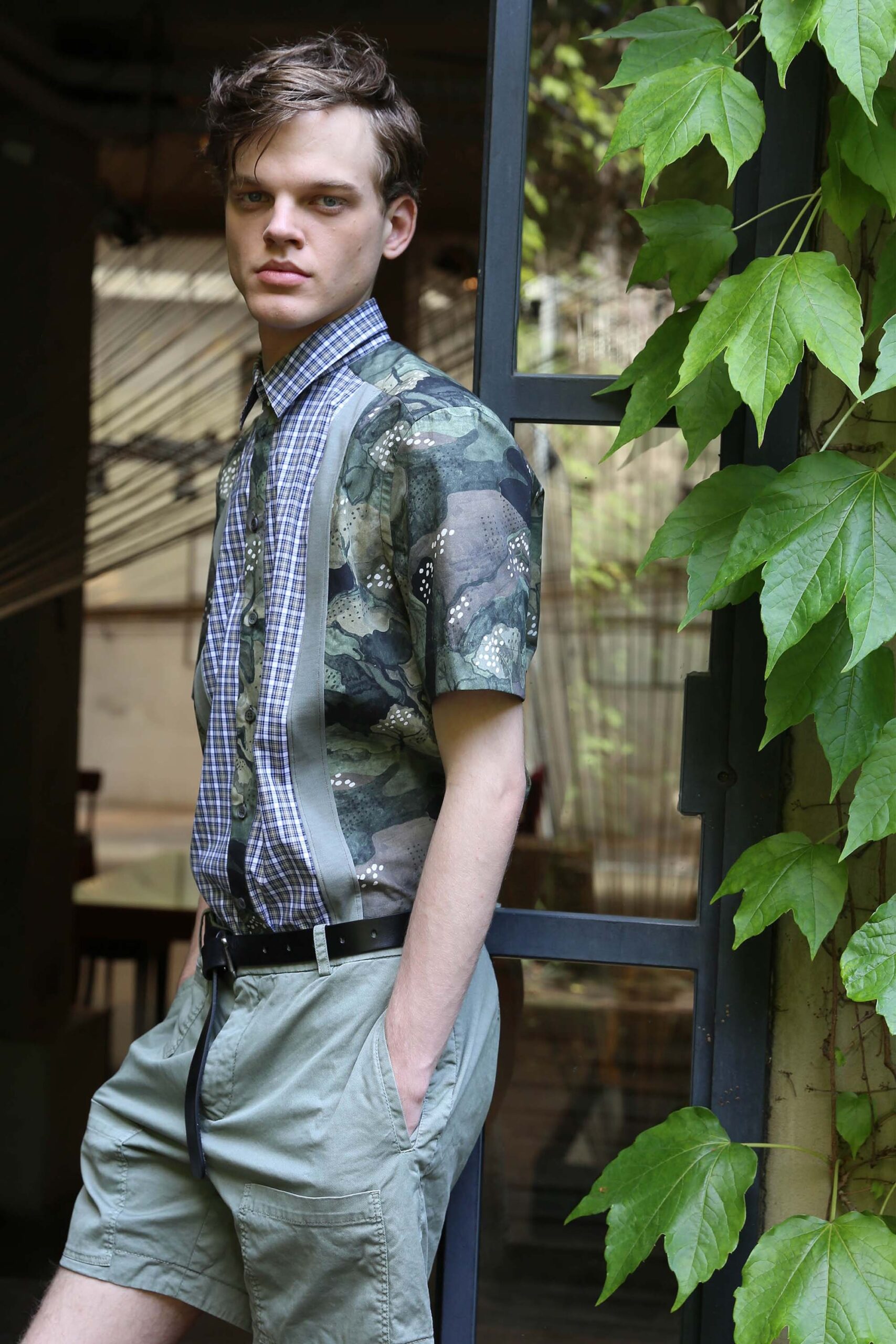 fitted green printed shirt and gray shorts