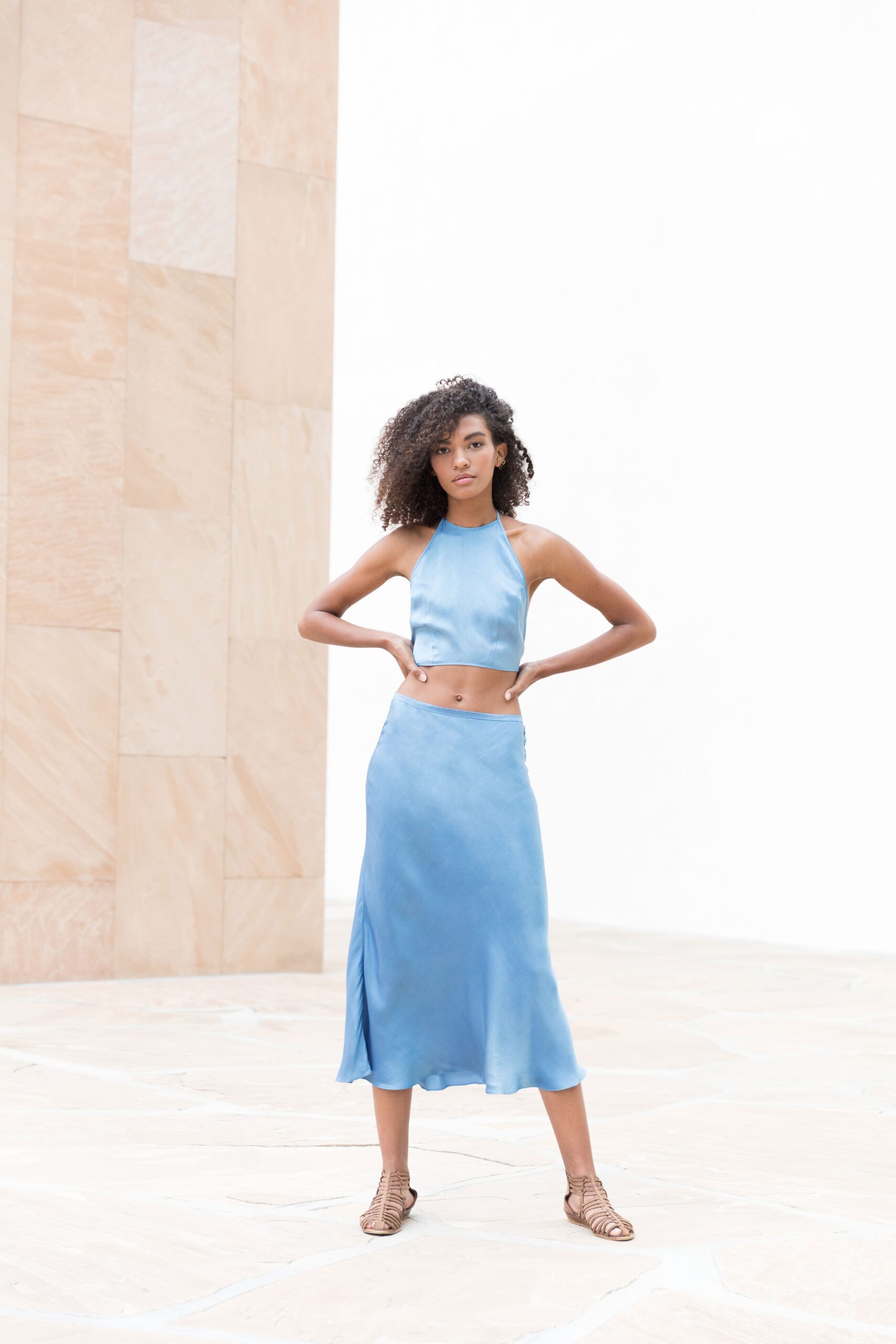blue silk sleeveless high-neck fitted flowing cropped top