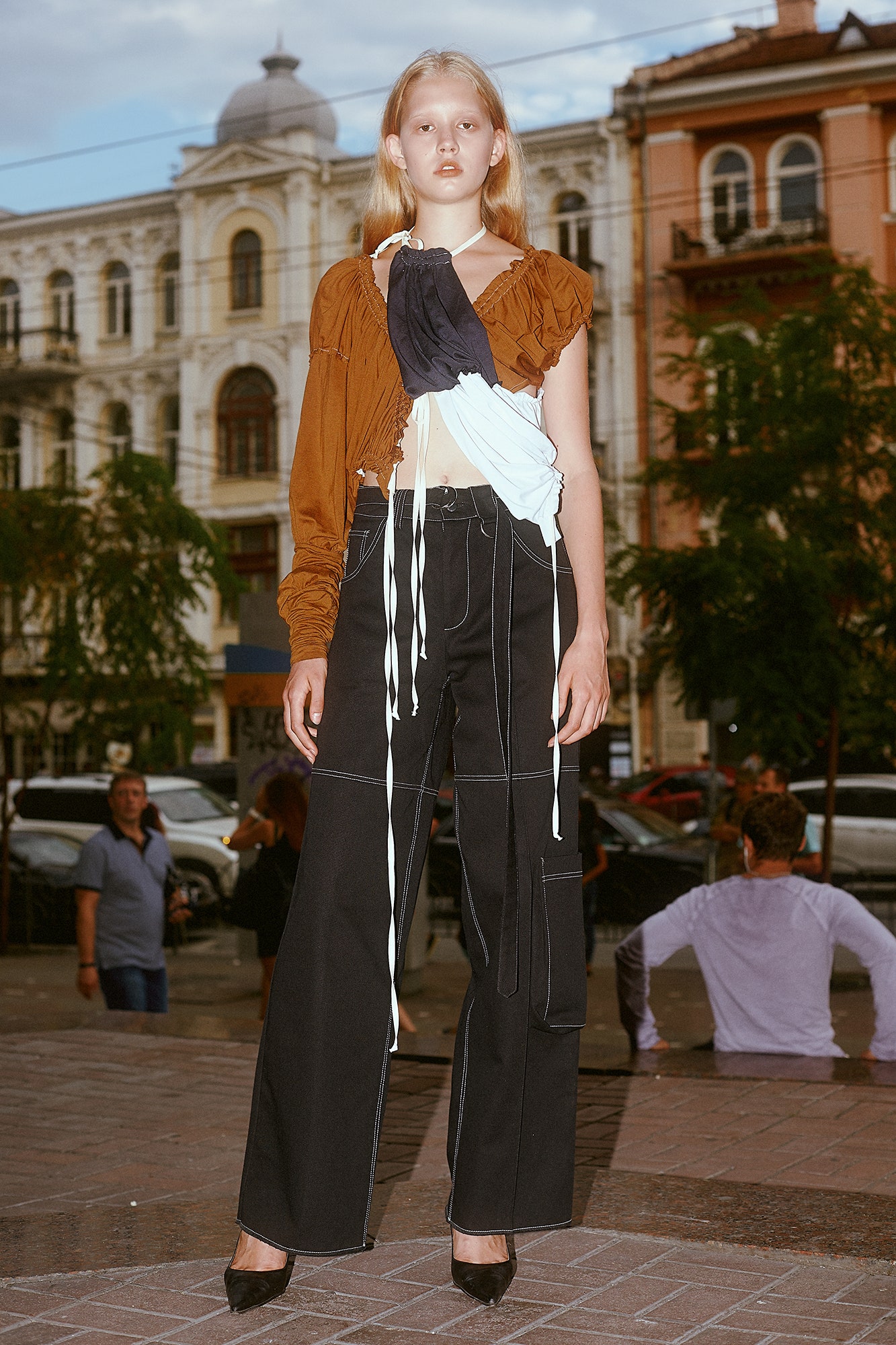 brown and blue fitted top with relaxed black pants