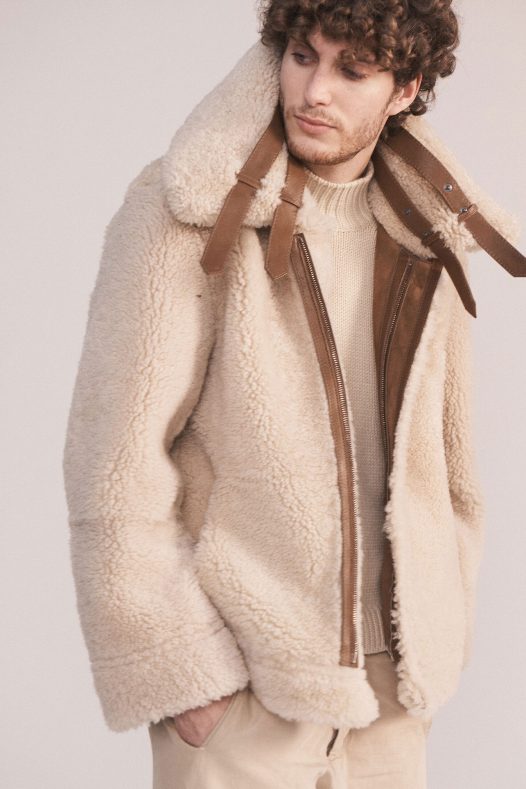 beige faux-fur jacket and cream sweater