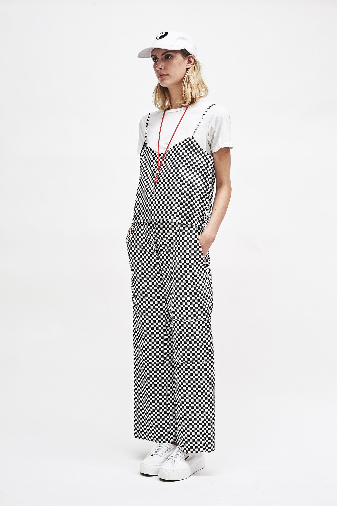 black sleeveless v-neck relaxed checked pockets jumpsuit