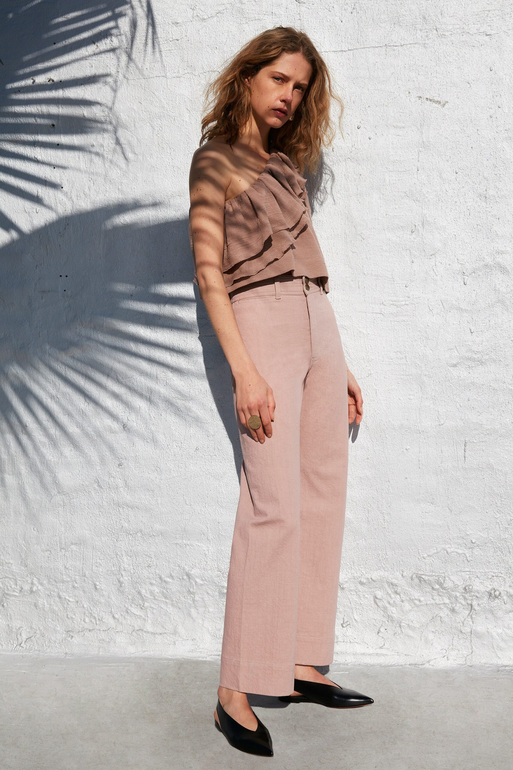 beige pleated top with pink pants