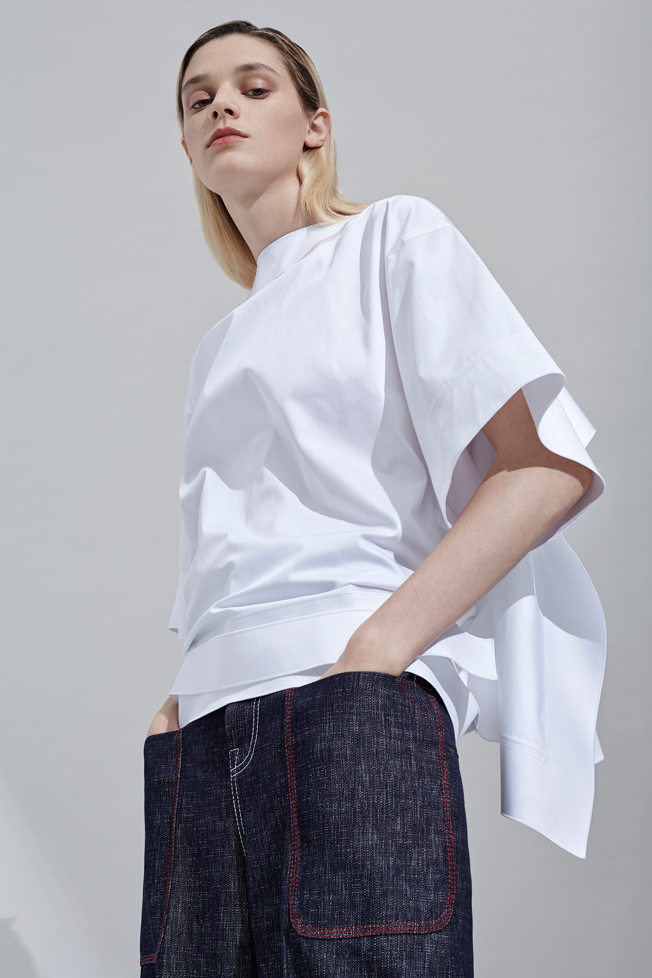 white relaxed top with blue denim pants
