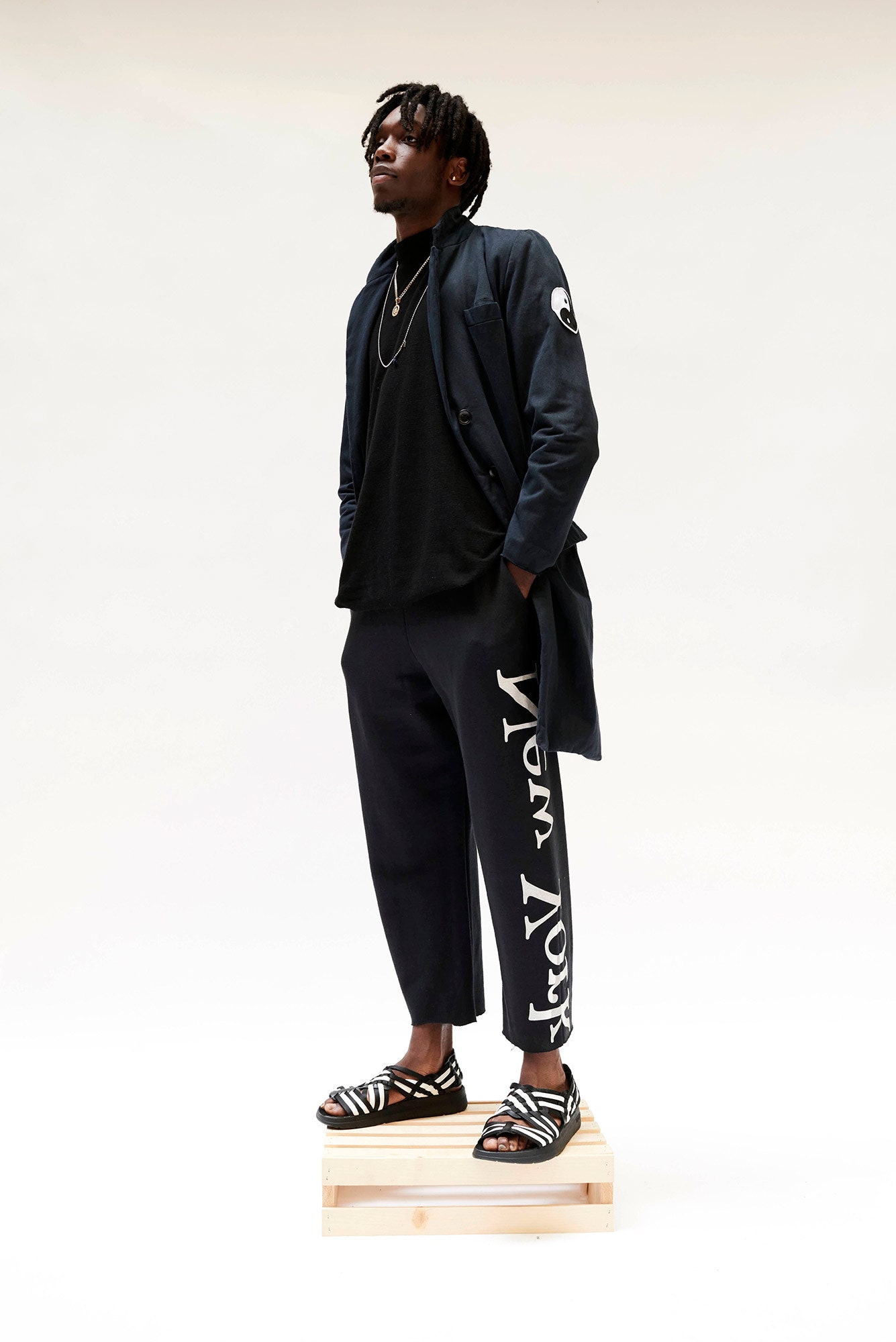 black relaxed coat with printed pants