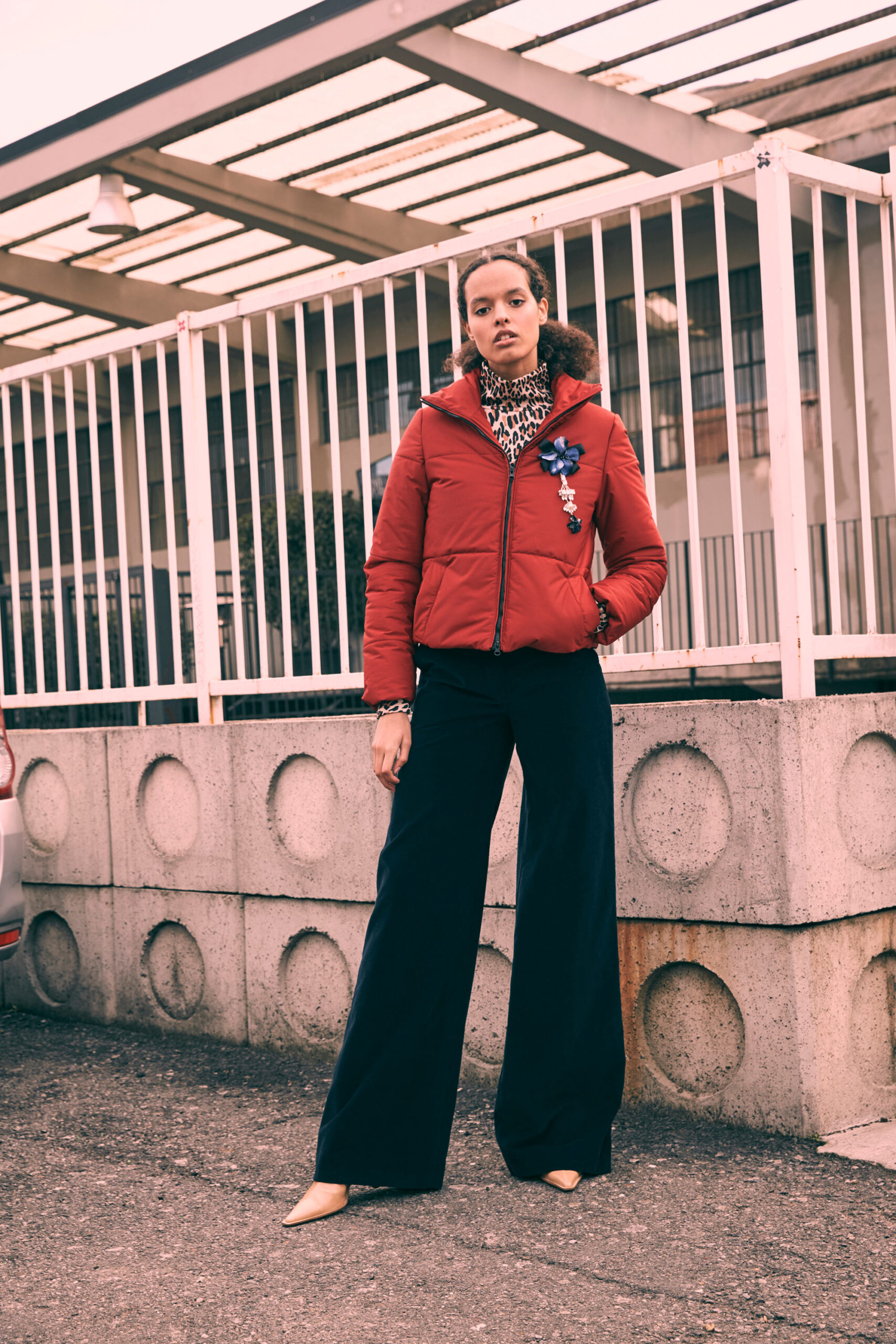 red fitted jacket with black pants