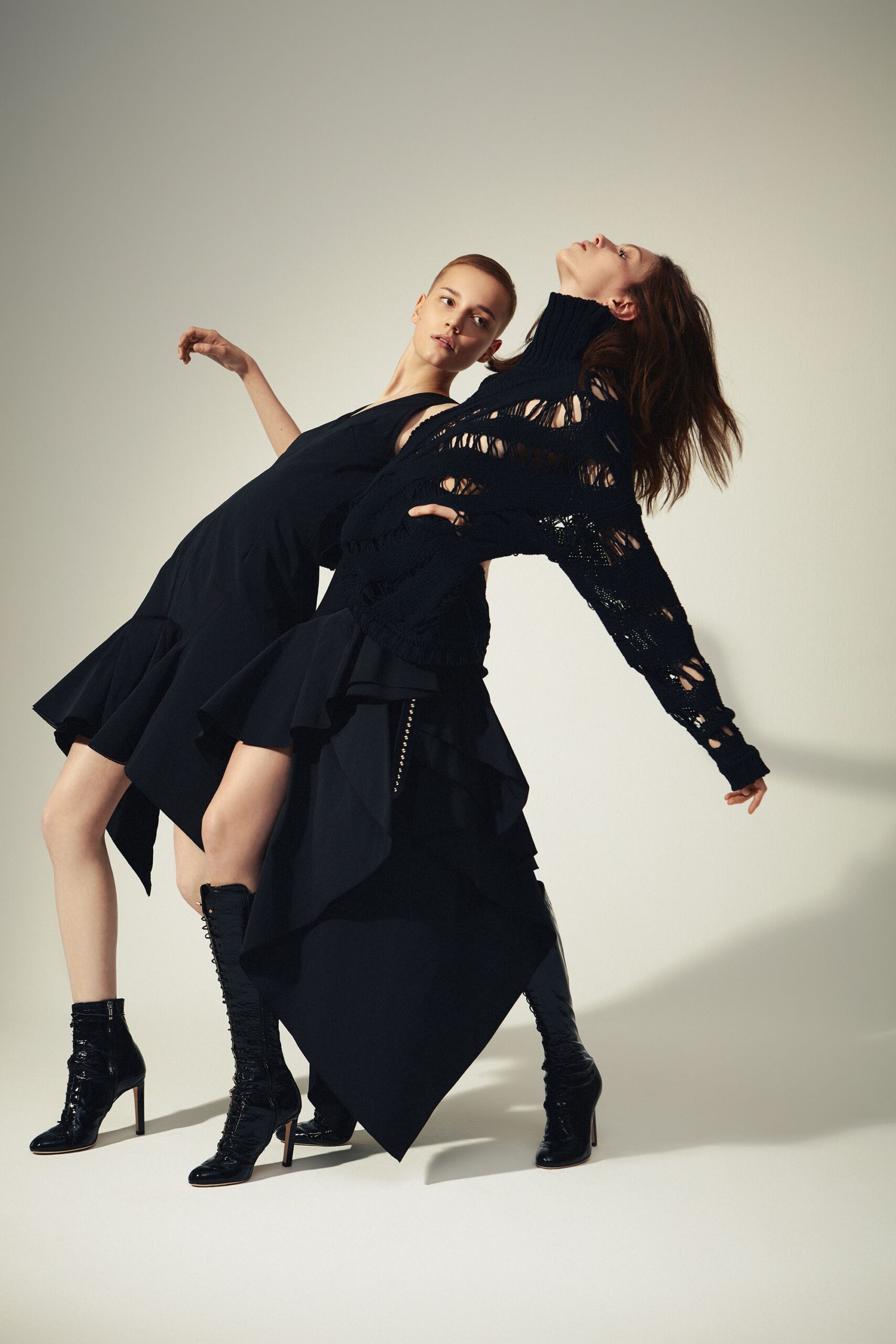 black asymmetric mini dress and fitted sweater