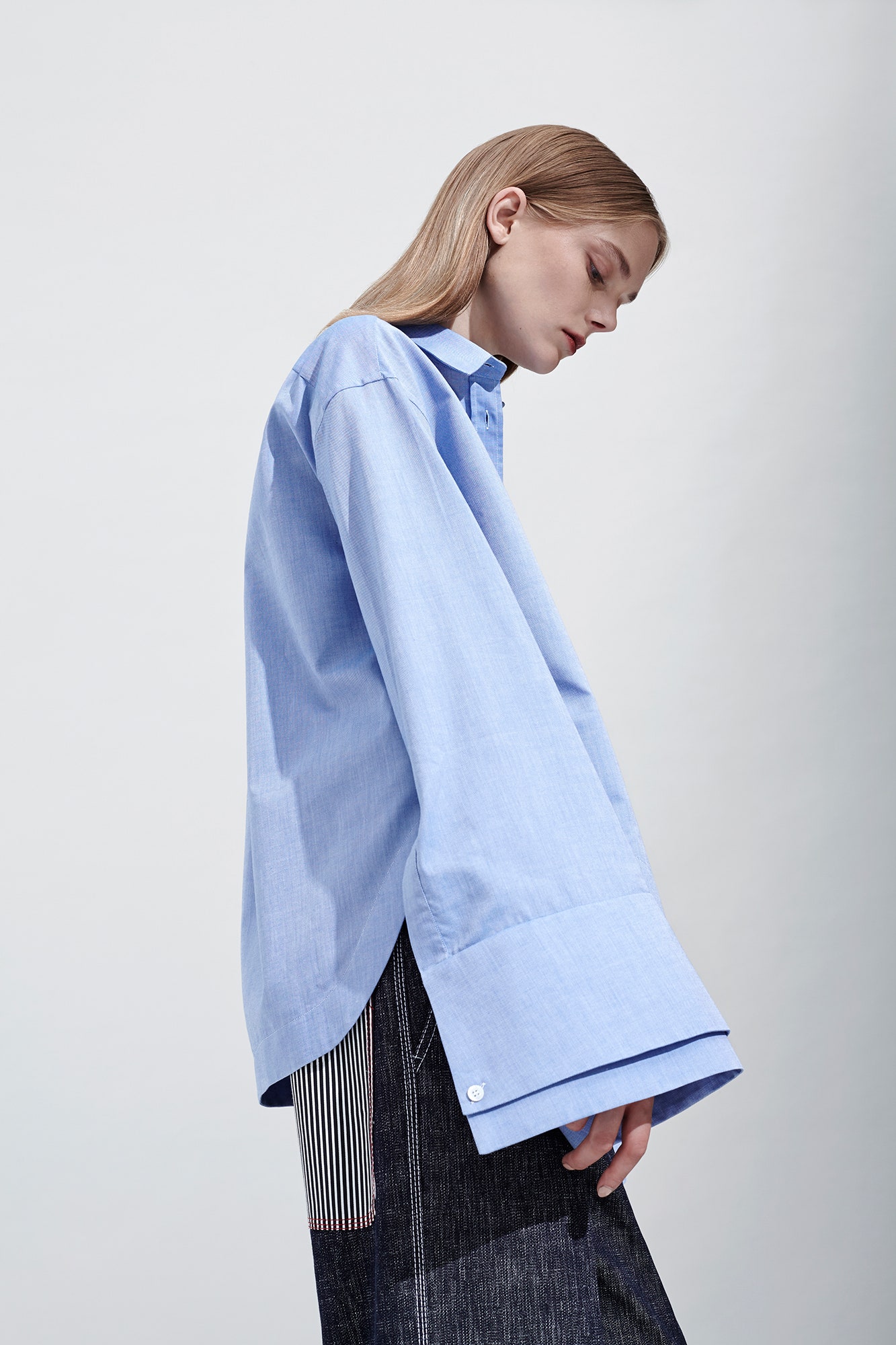 oversized blue shirt with relaxed denim pants