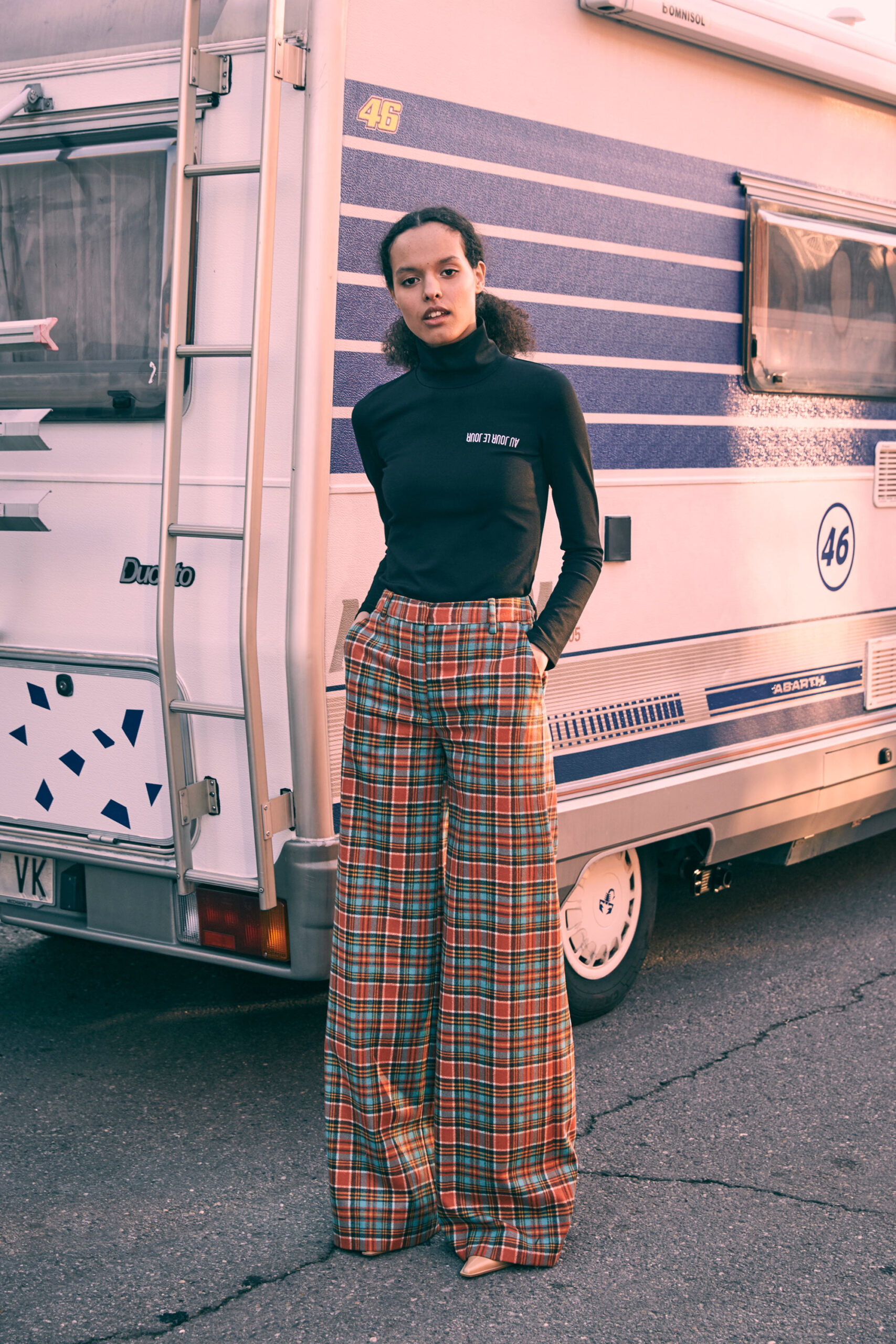 black fitted turtleneck top and plaid wide-leg pants