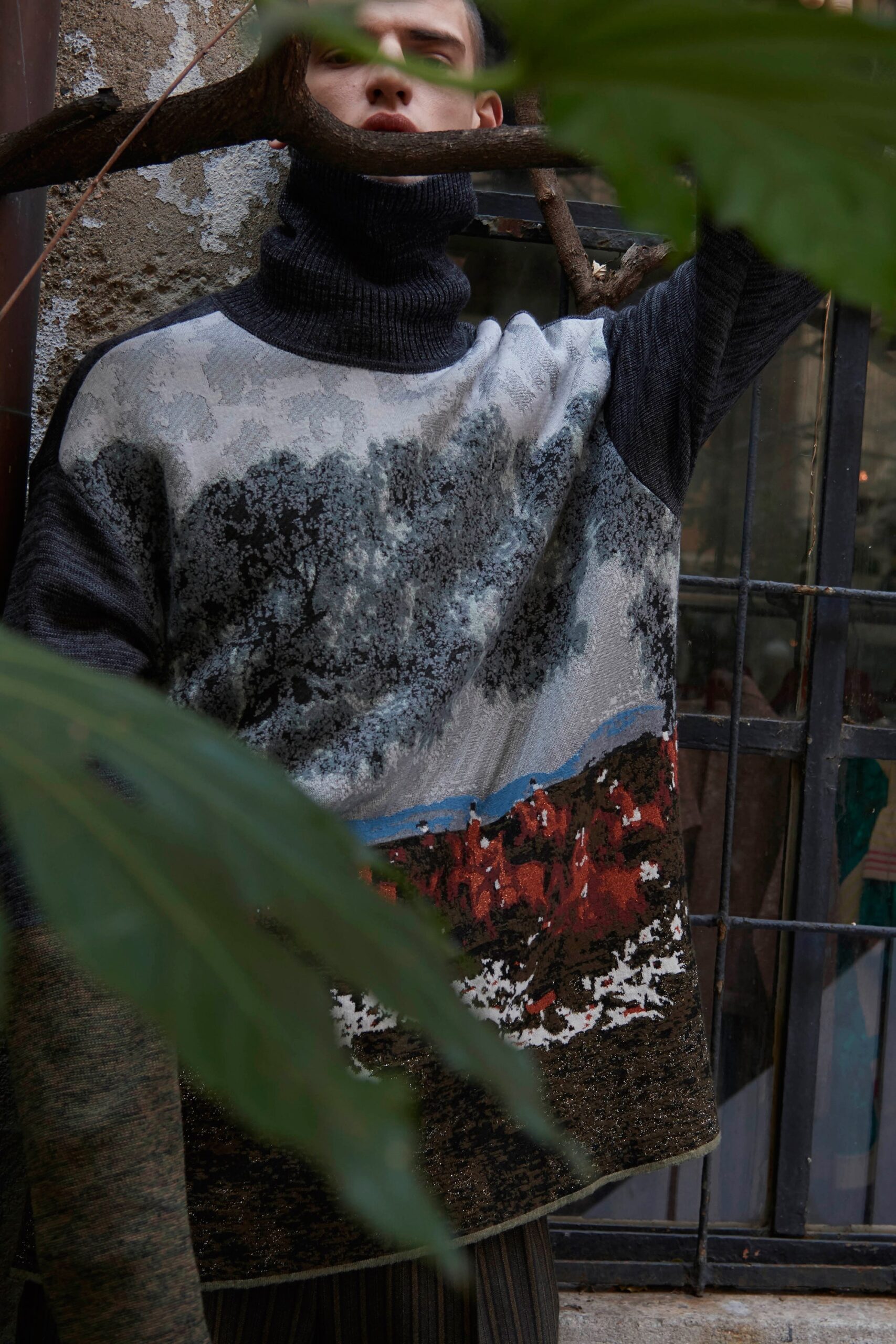 gray printed relaxed sweater with black pants