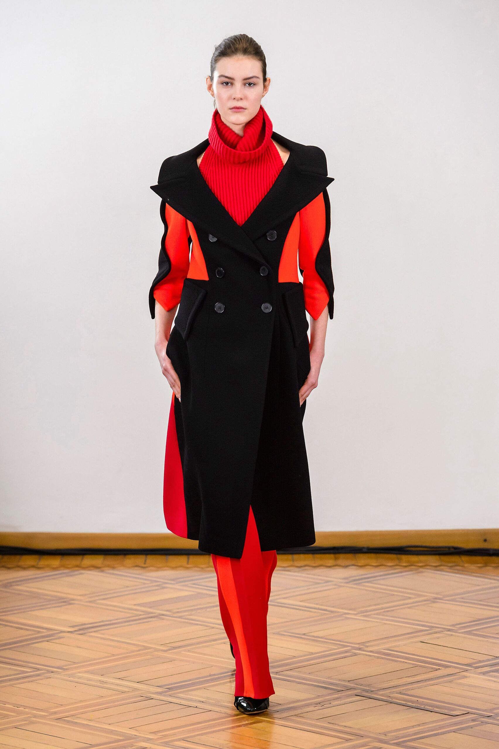 black coat red fitted top and pants