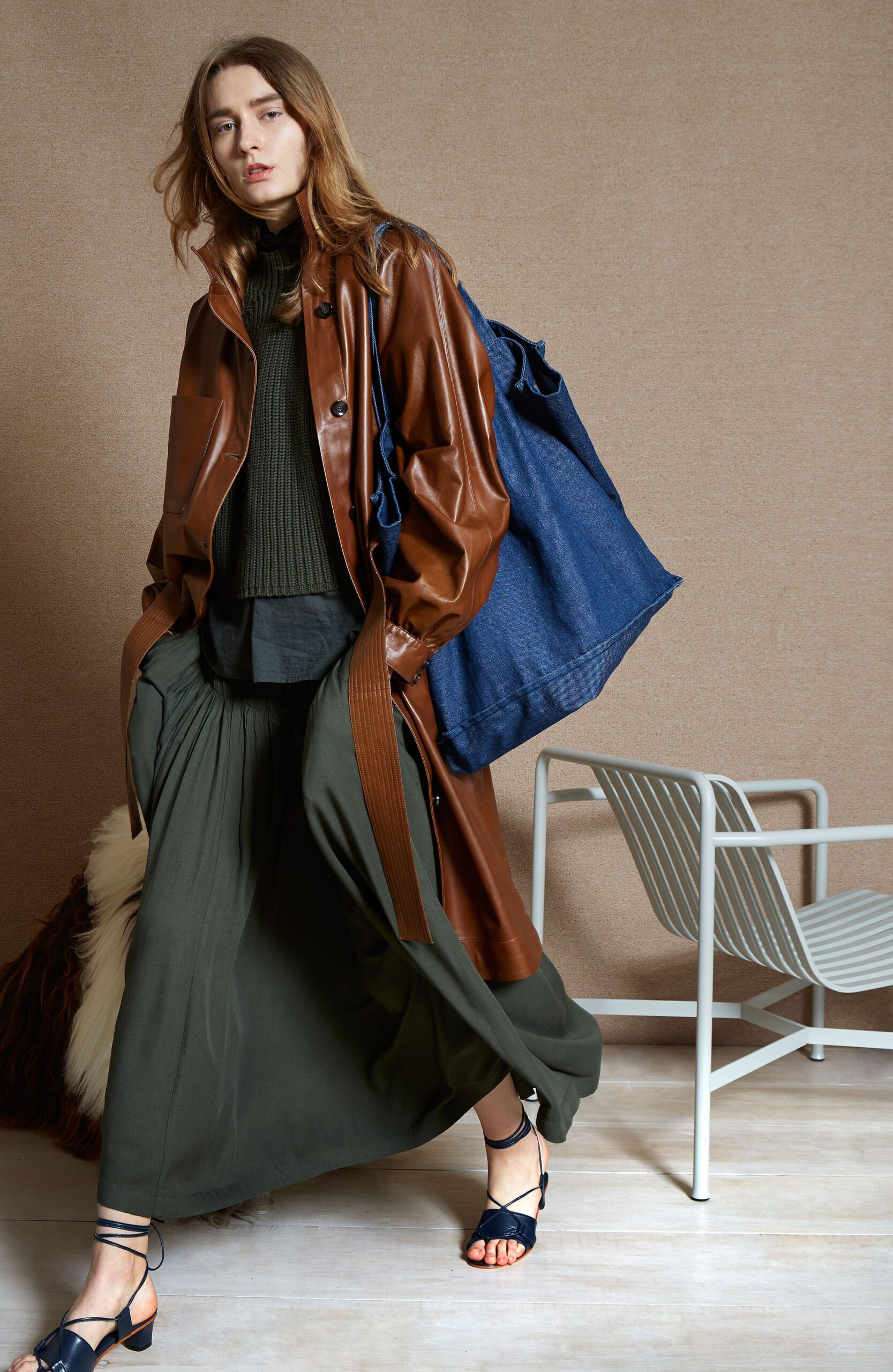 brown leather coat with green sweater