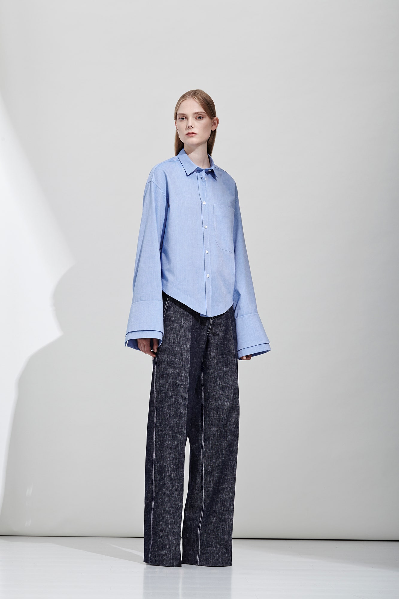 blue cotton shirt and gray denim pants